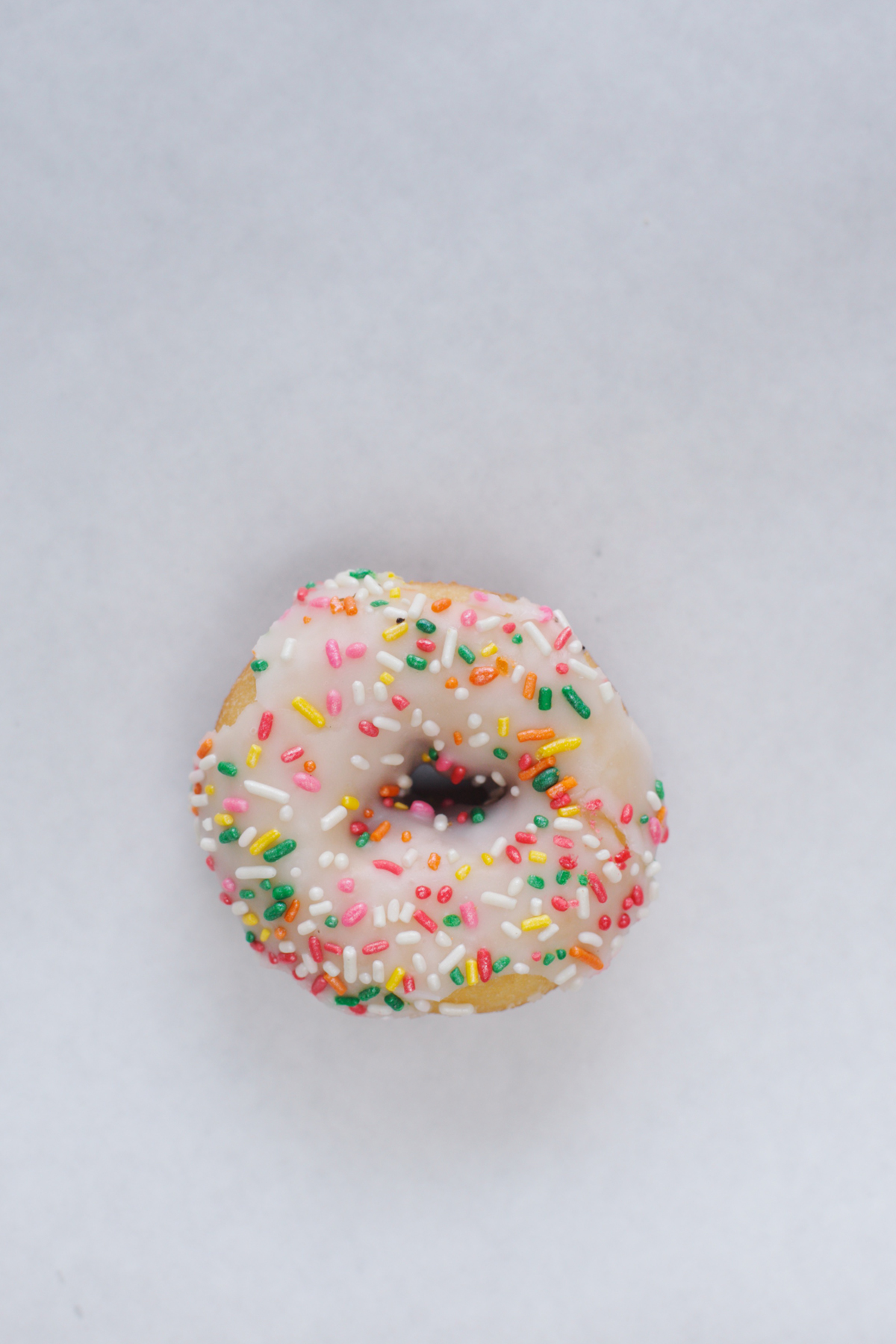 Order Vanilla Rainbow Sprinkle Donut food online from White Cup Donuts store, Gardena on bringmethat.com