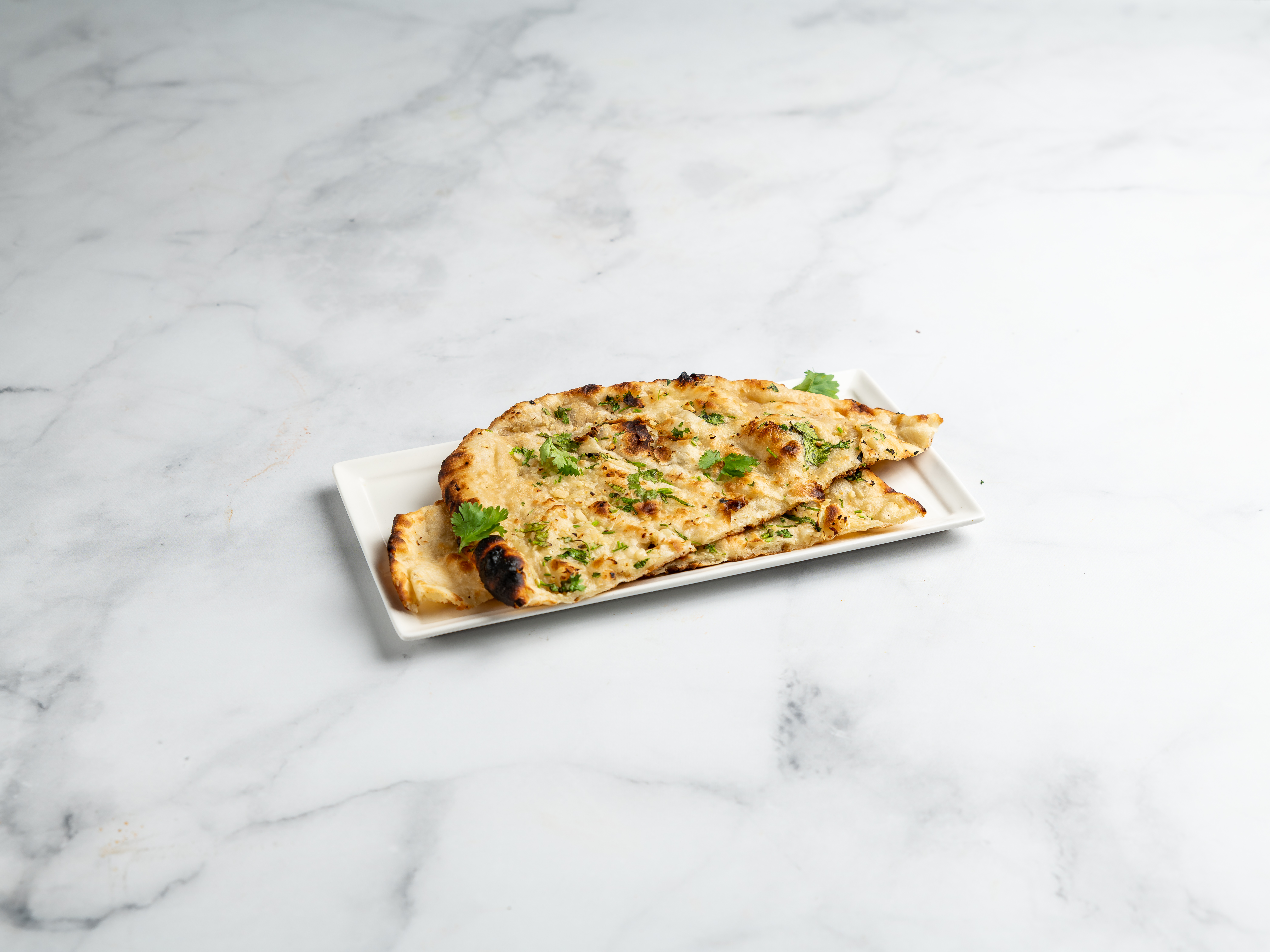 Order Garlic Naan food online from New Spice World store, Corona on bringmethat.com