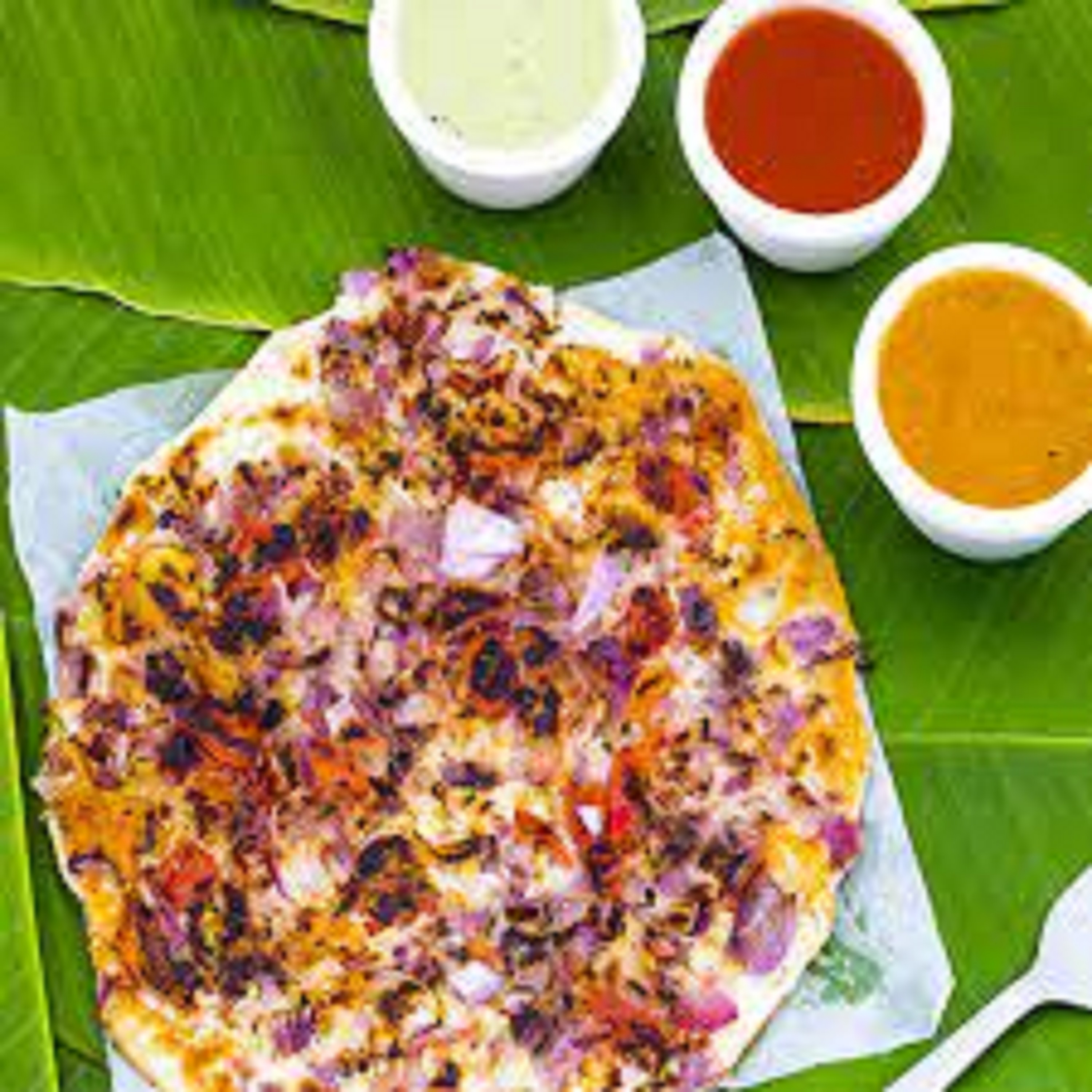 Order Uthappam Onion & Tomato food online from Swagath Plaza store, Norfolk on bringmethat.com