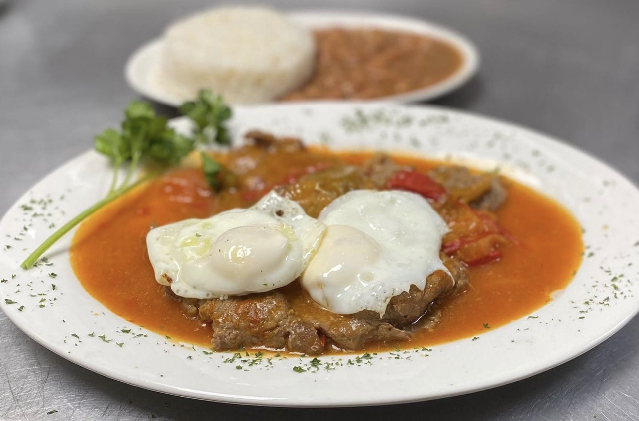 Order Bistec A Caballo / Steak in Creole sauce Topped with Eggs. food online from Mr. Mario store, College Point on bringmethat.com