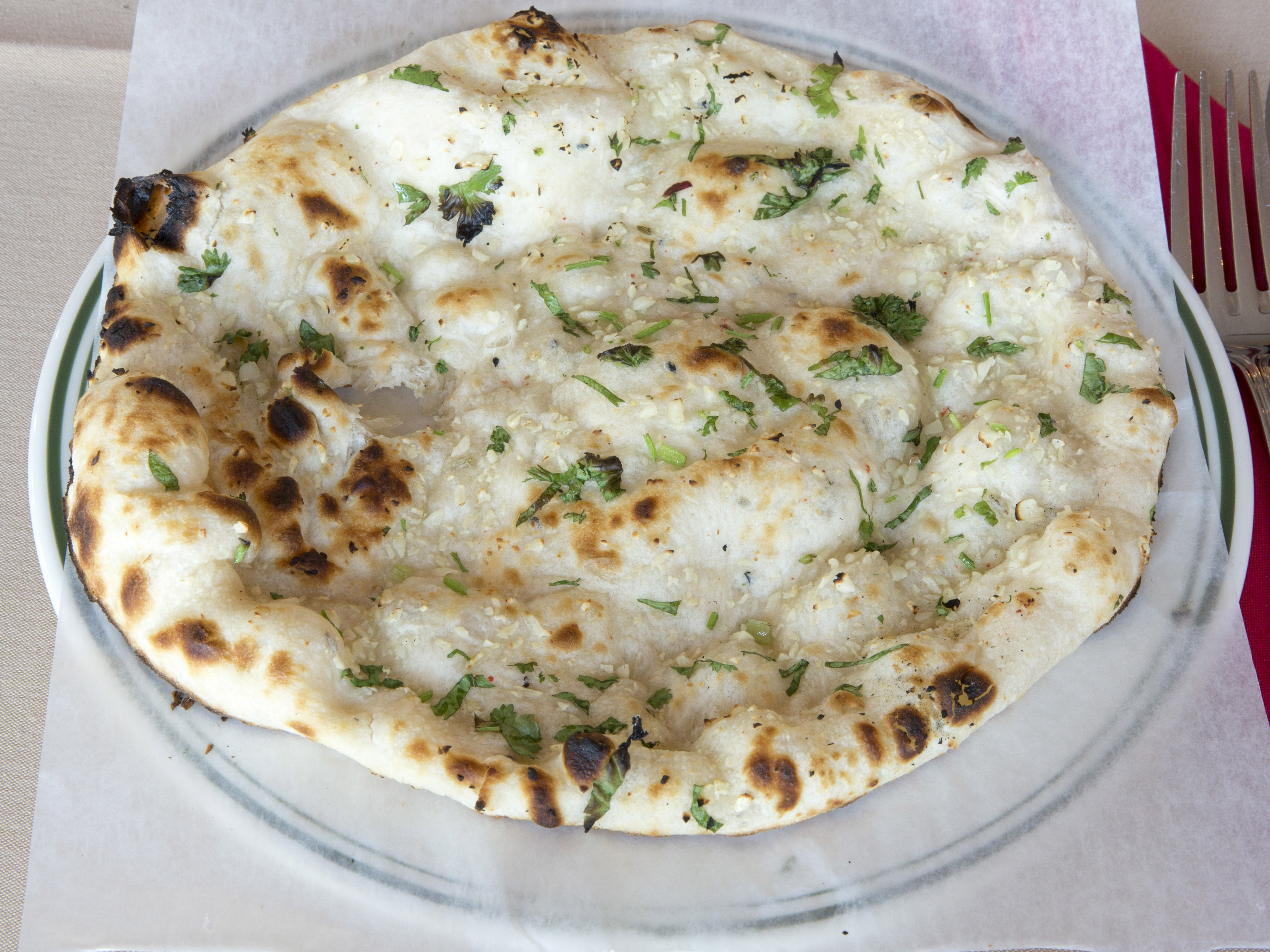Order Garlic Naan food online from India's Restaurant store, Los Angeles on bringmethat.com