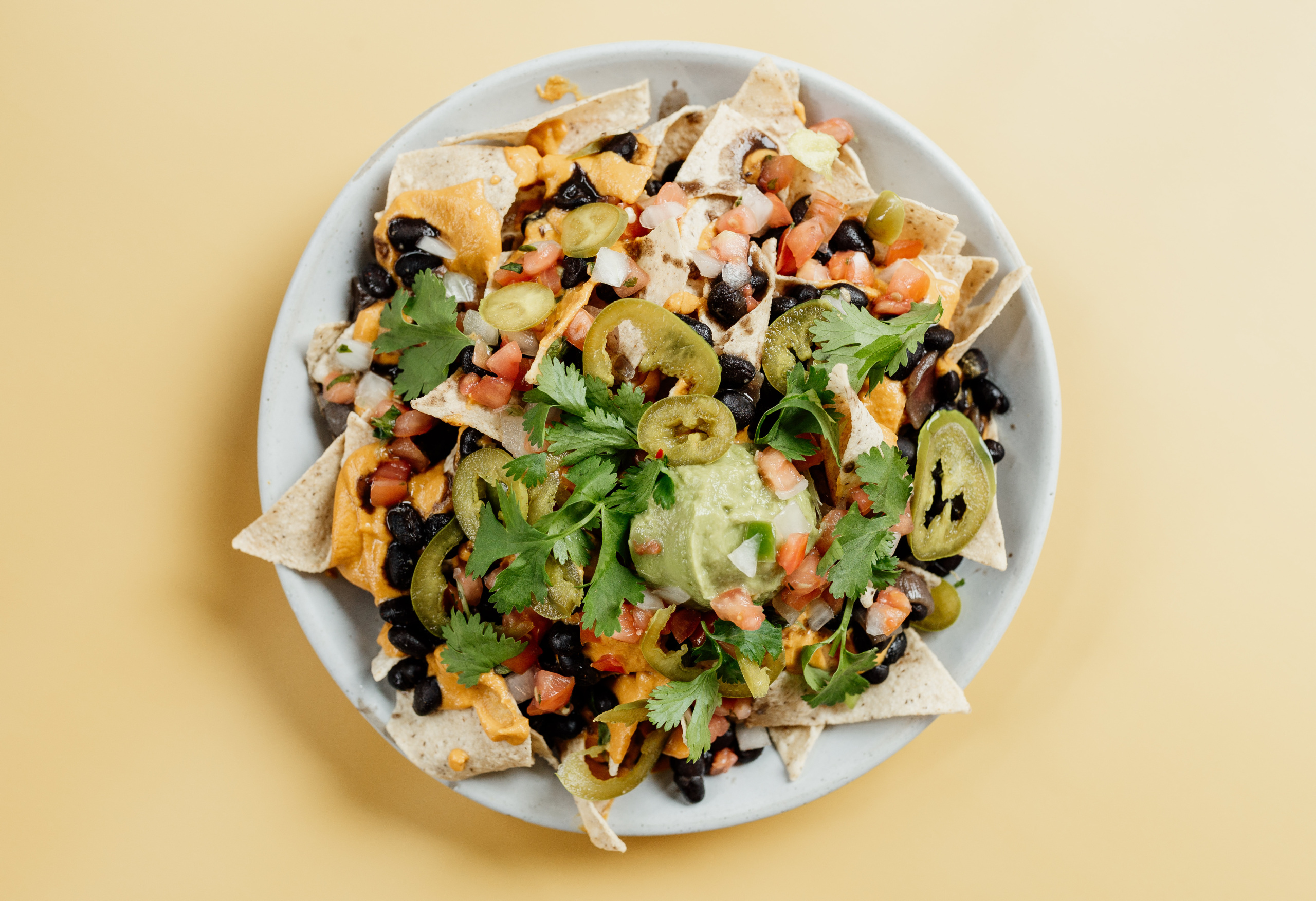 Order Loaded Nachos food online from Tribal All Day Cafe store, Dallas on bringmethat.com