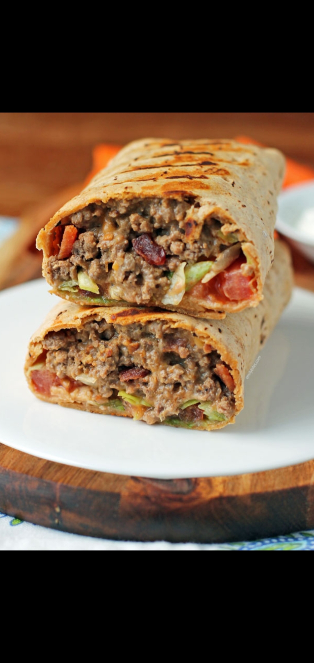 Order Bacon & Beef Burrito (ground beef,  bacon strips taco seasoning shredded cheddar tomatoes  mustard Chipotle sauce & side sour cream) food online from American Gourmet Foods Deli store, New York on bringmethat.com