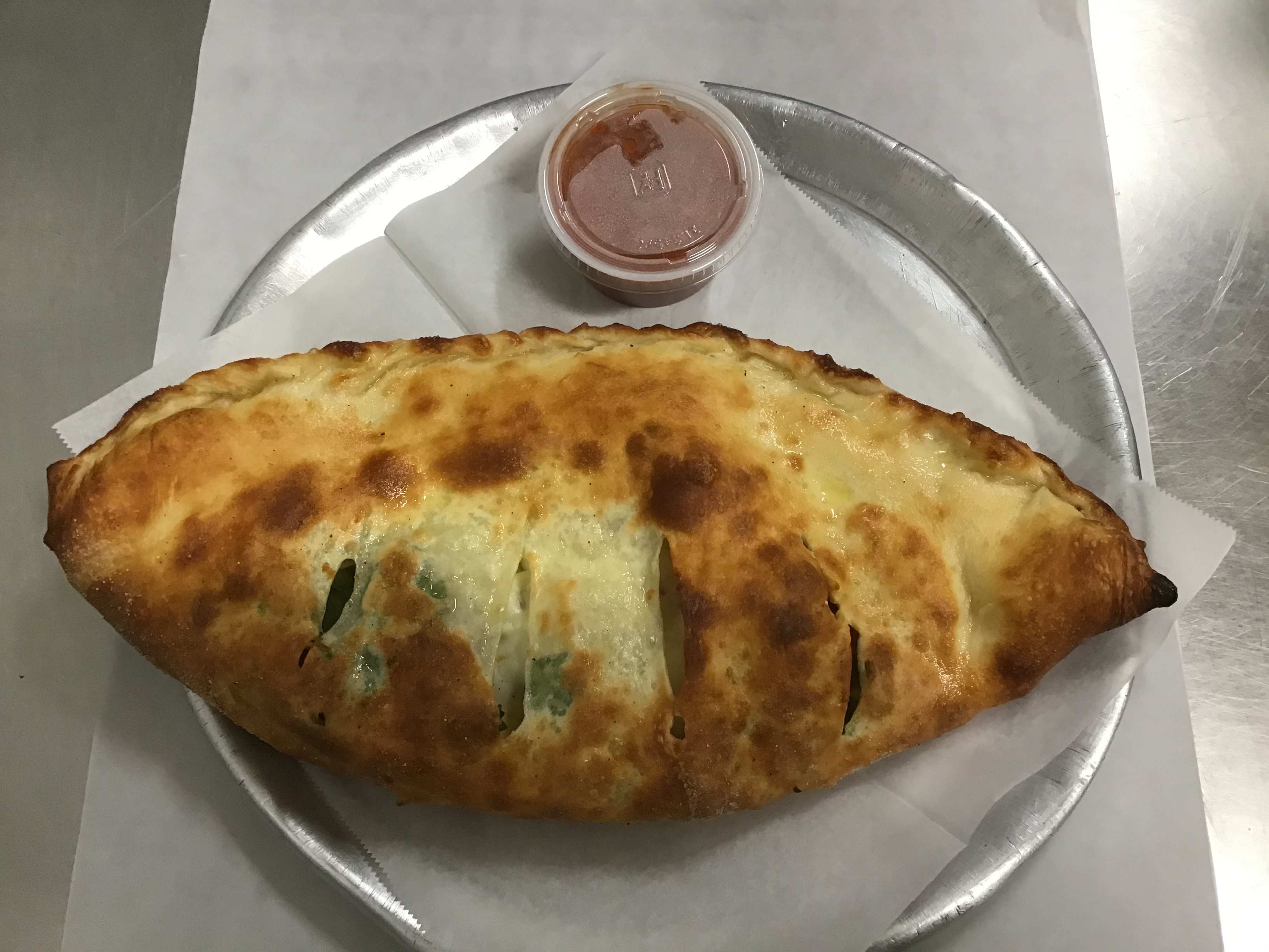 Order Spinach, Garlic and Cheese Calzone food online from Via Roma store, North Conway on bringmethat.com