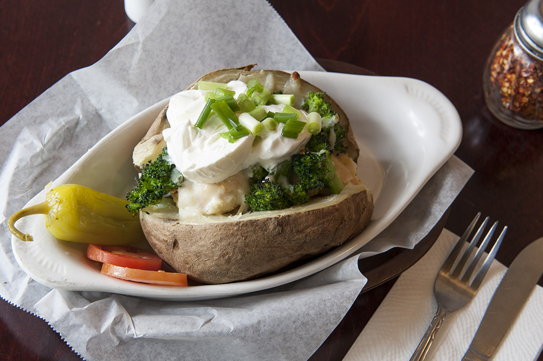 Order Baked Potato with Cheese and Sour Cream food online from Tottino's Pizza store, Inglewood on bringmethat.com