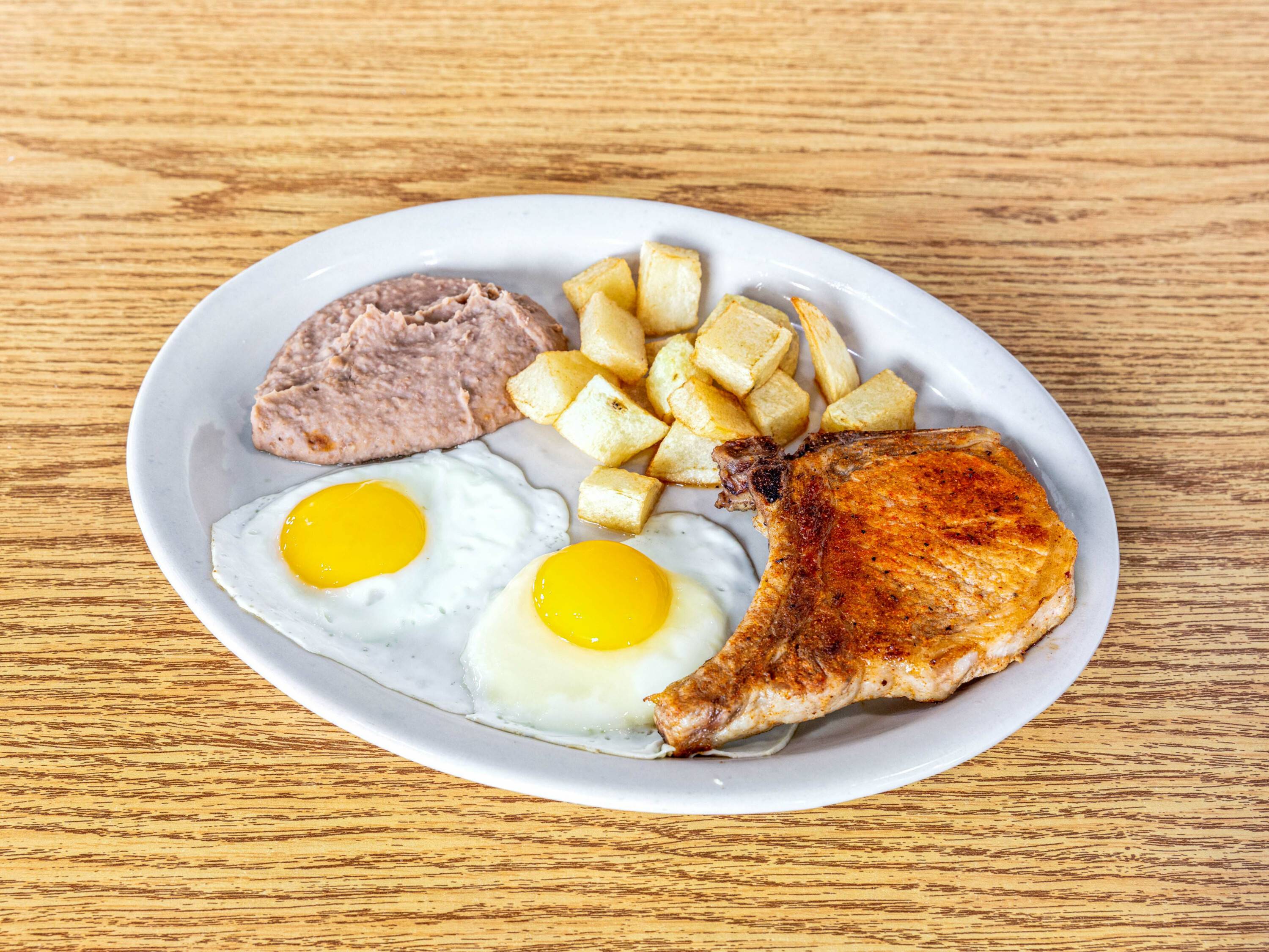 Order Pork Chop and Eggs food online from La Coronela Mexican Restaurant store, San Antonio on bringmethat.com