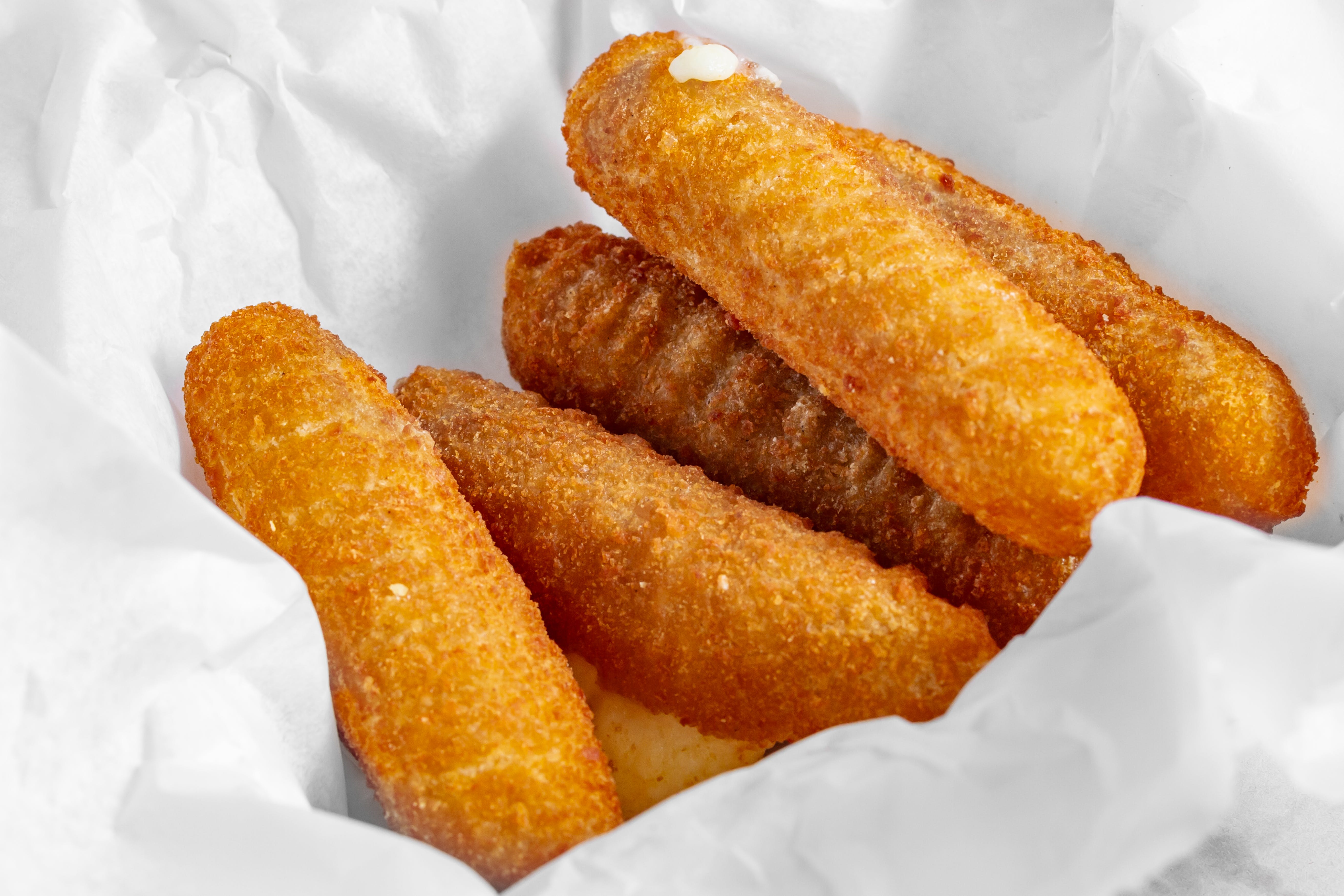 Order Mozzarella Sticks - 5 Pieces food online from Wings Things N More store, Catonsville on bringmethat.com