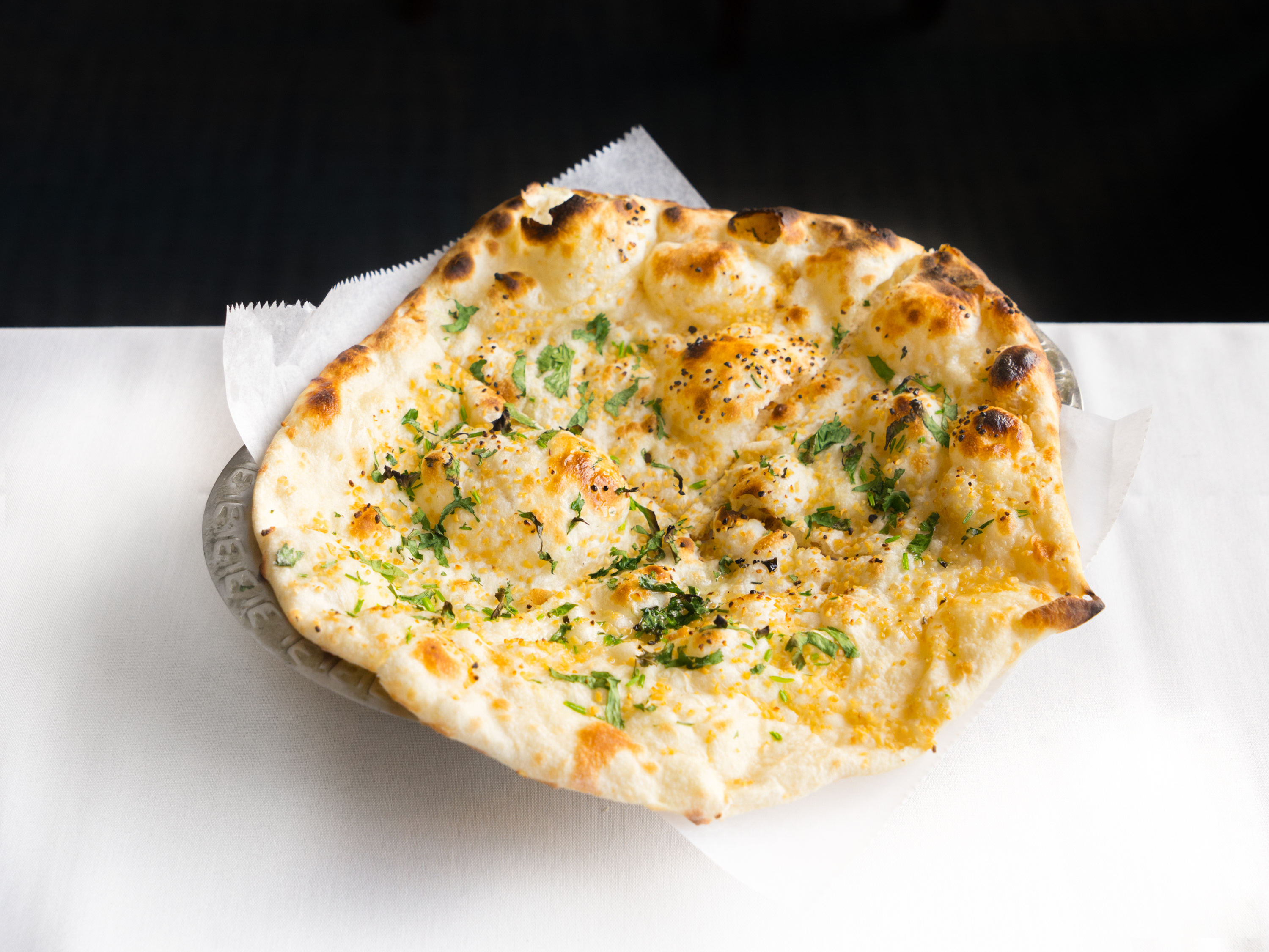 Order Garlic Naan food online from India Palace store, Burnsville on bringmethat.com