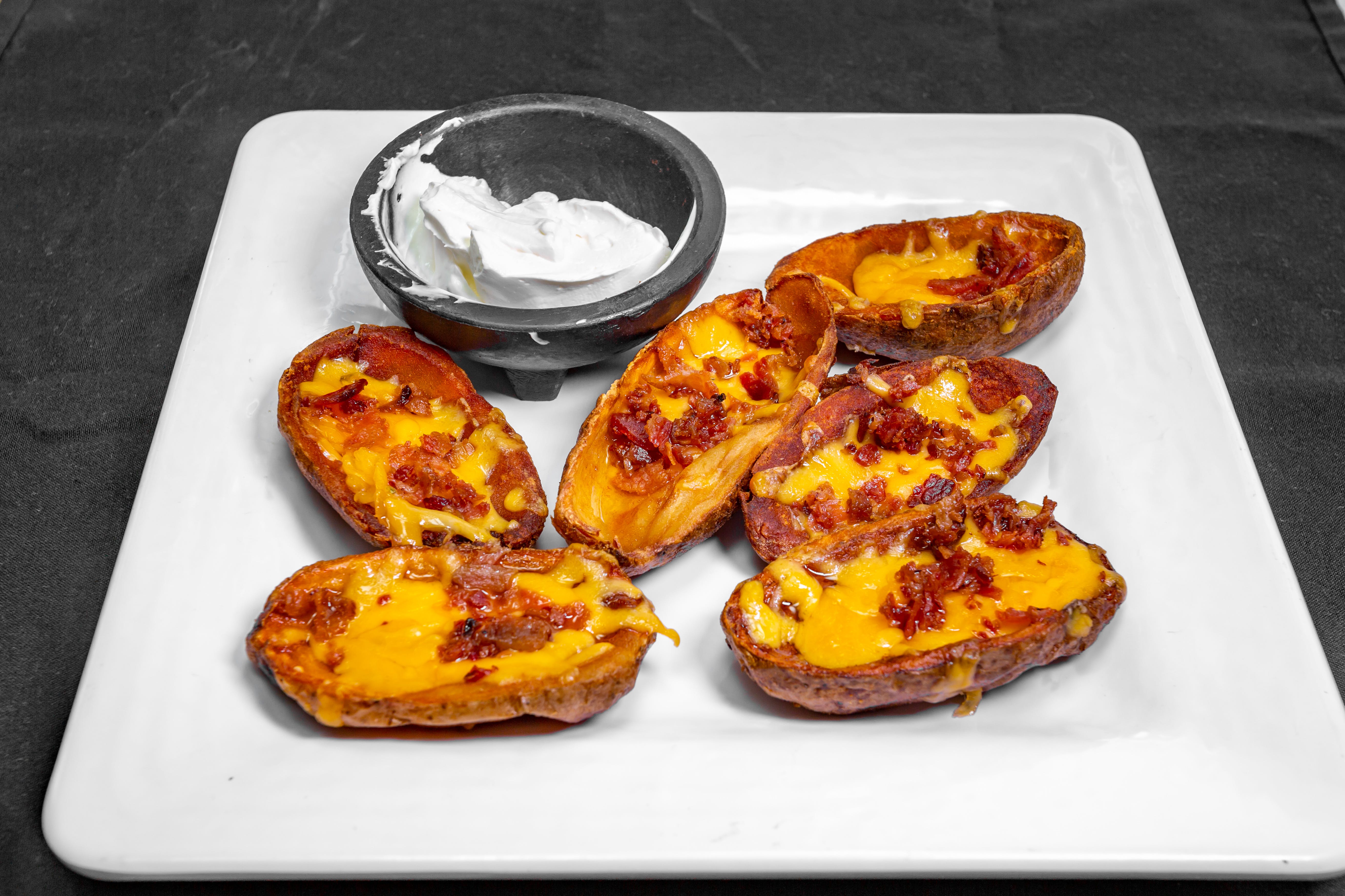 Order Potato Skins - 6 Pieces food online from Mannino's Pizzeria & Italian Eatery store, Pottstown on bringmethat.com