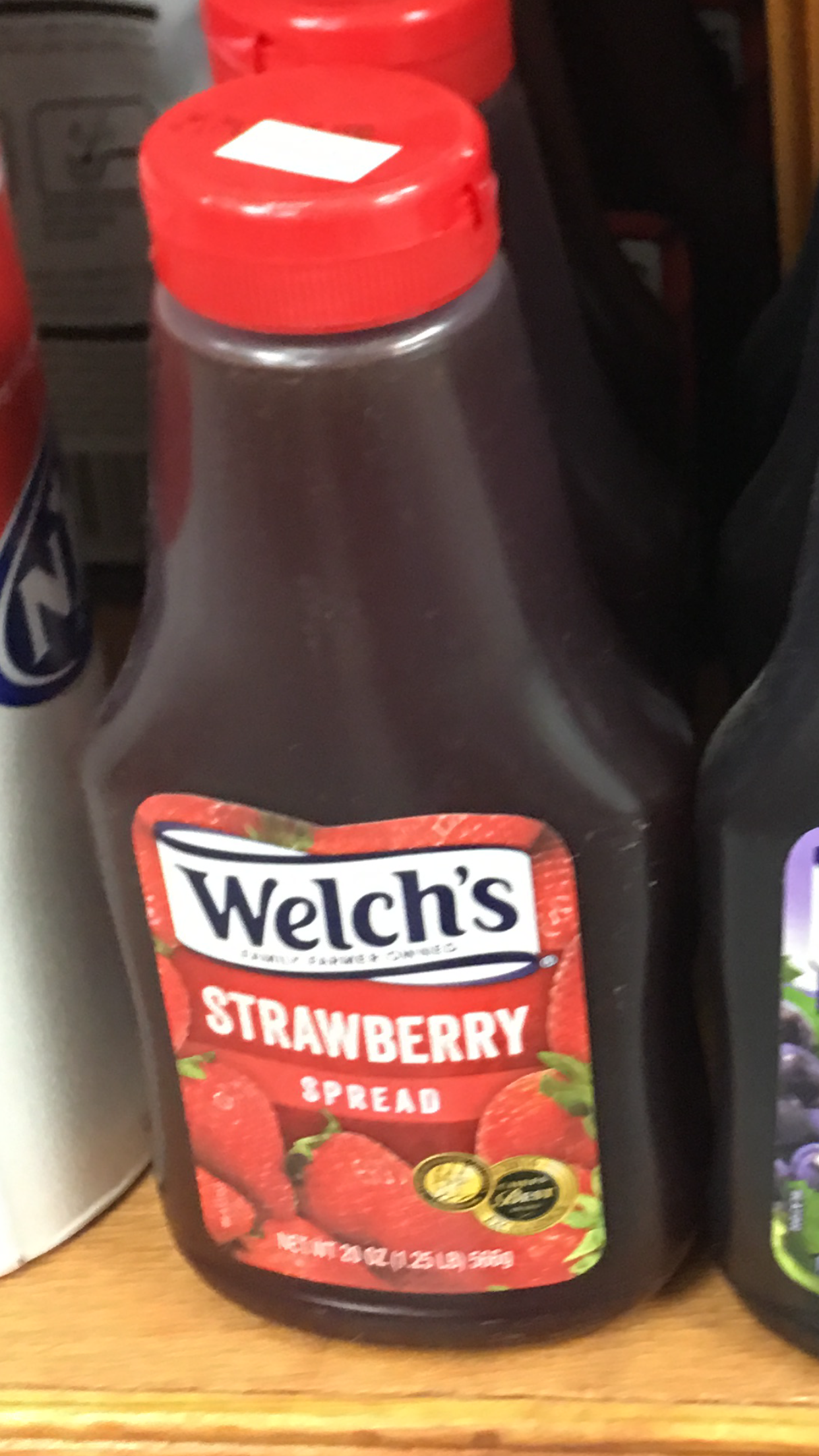 Order Welch's strawberry spread 20oz squeeze bottle food online from Crescent Gourmet store, Astoria on bringmethat.com