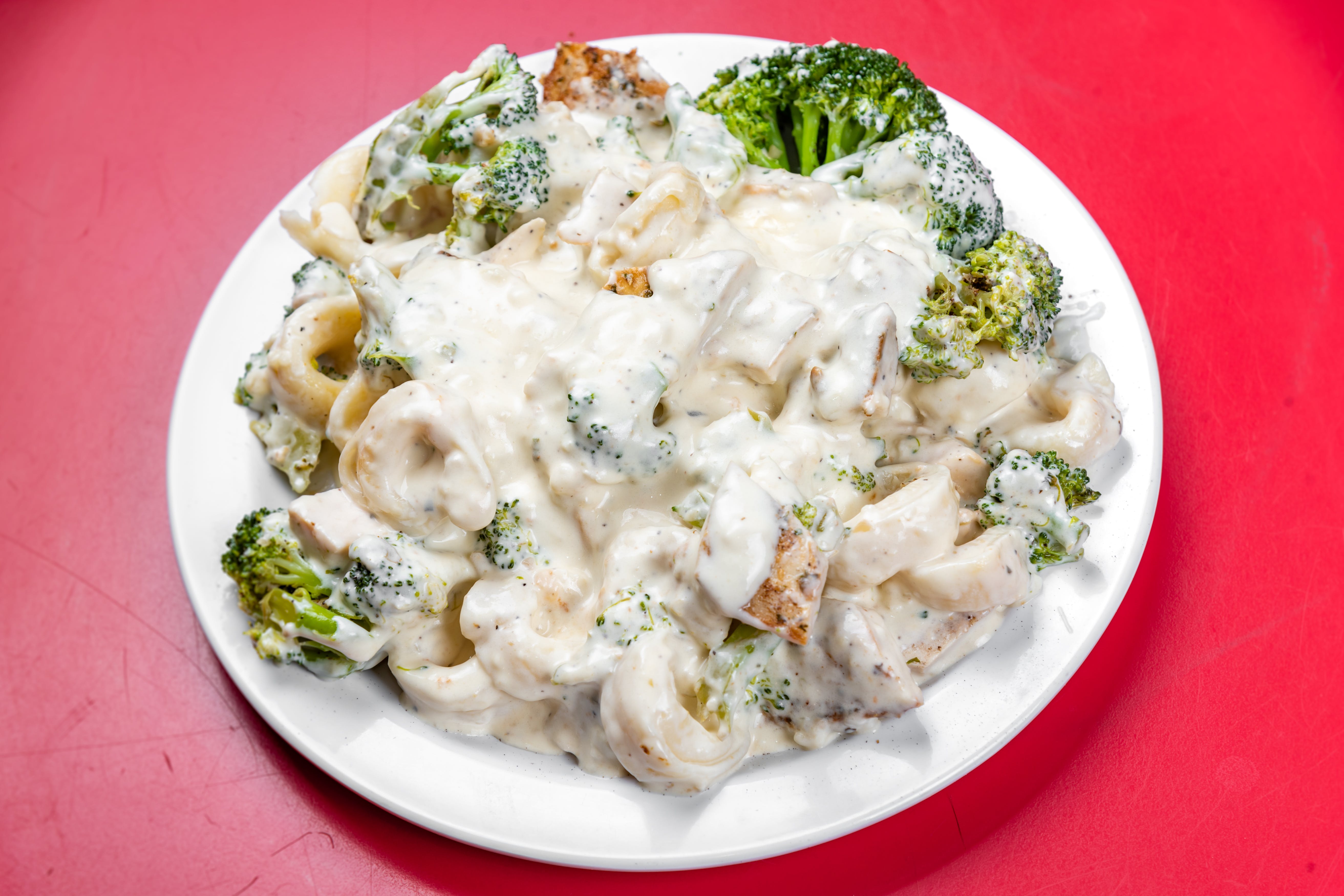 Order Tortellini Alfredo - Entree food online from The Grotto Pizzeria store, New York on bringmethat.com