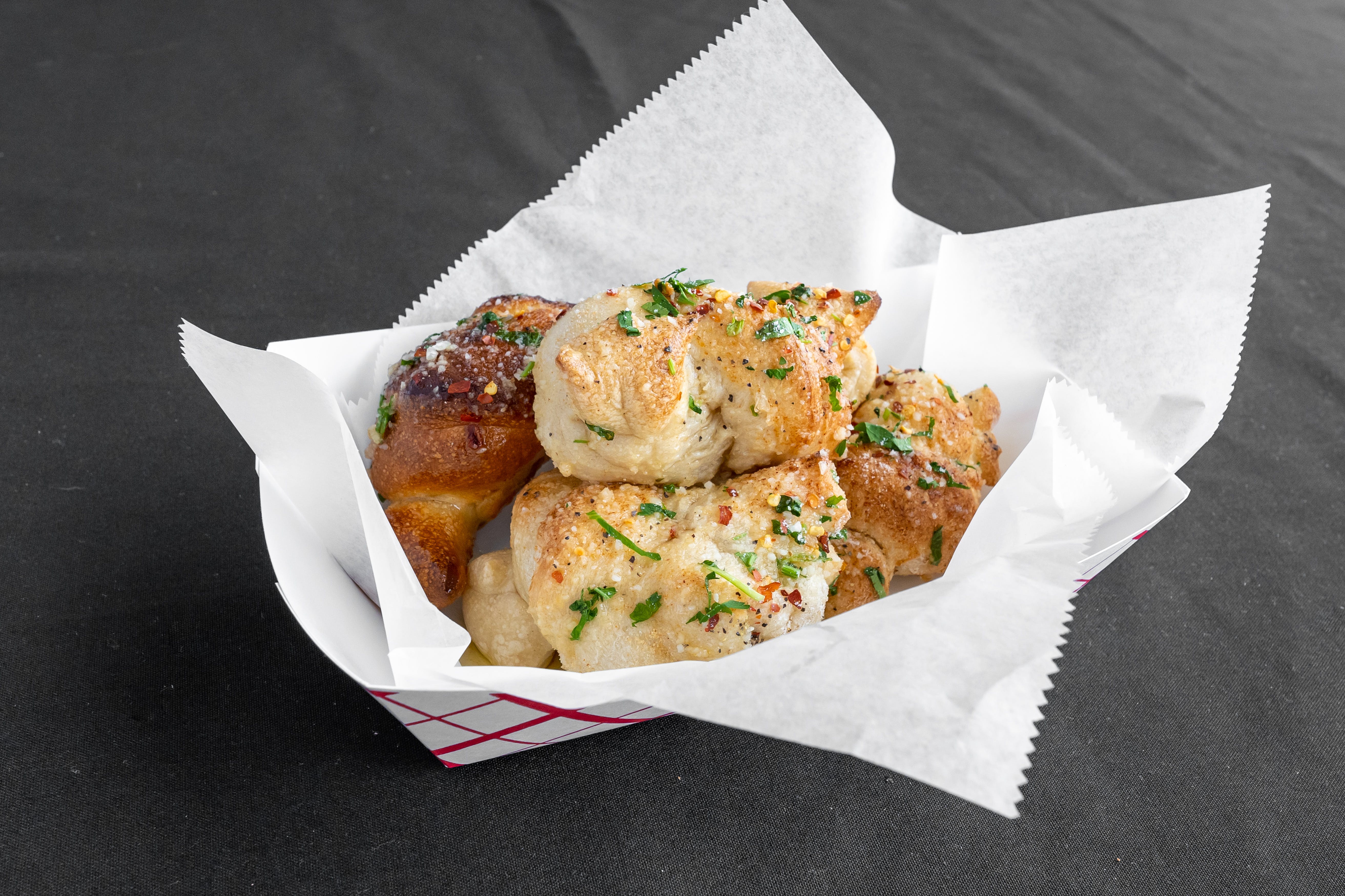Order Garlic Knots - 6 Pieces food online from Pizza Village Tomato Pie store, Lahaska on bringmethat.com