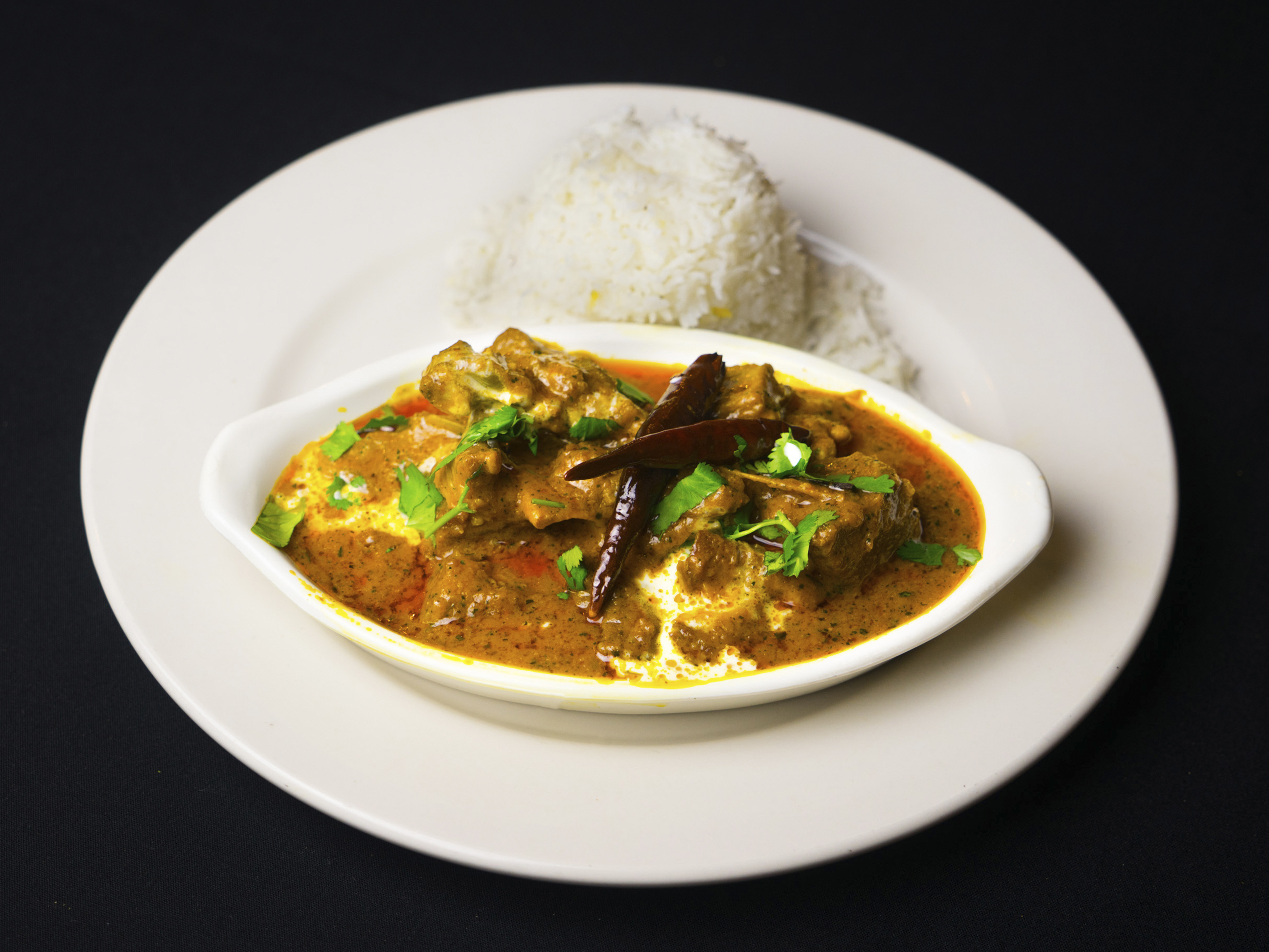 Order Goat Curry food online from Tandoor Restaurant store, Minneapolis on bringmethat.com