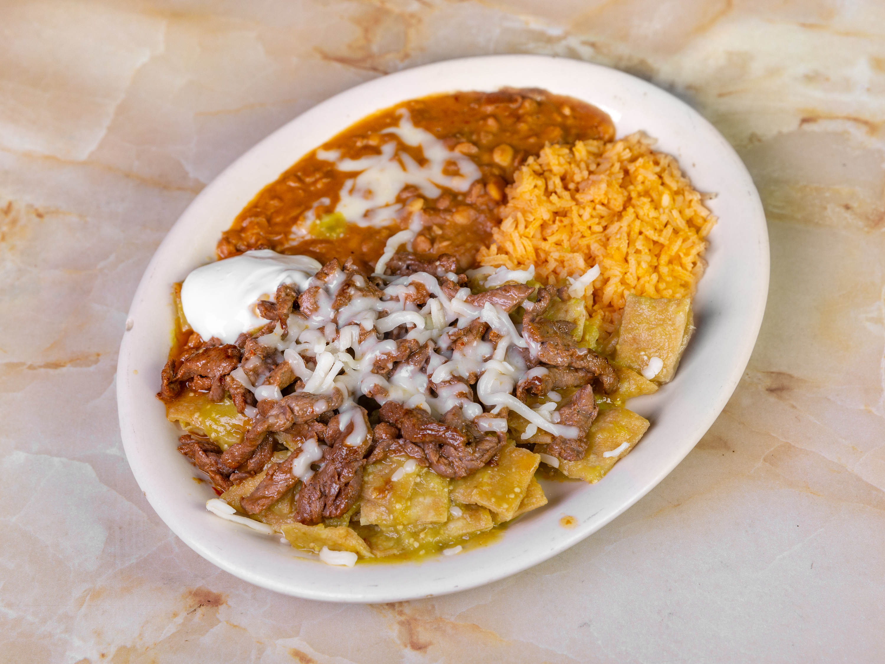 Order Chilaquiles (Green or Red) food online from Oasis Mexican Grill store, Springdale on bringmethat.com