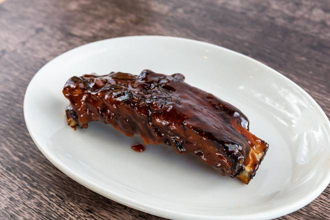 Order Pecan Wood Smoked Beef Rib - 1 rib food online from Wood Ranch BBQ & Grill store, Cerritos on bringmethat.com