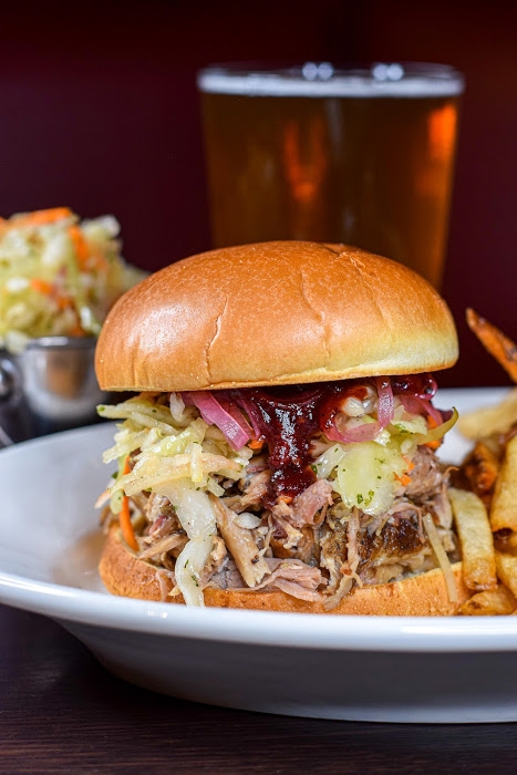 Order Pulled Pork Sandwich food online from C.A.Y.A. Smoke House Grill store, Walled Lake on bringmethat.com