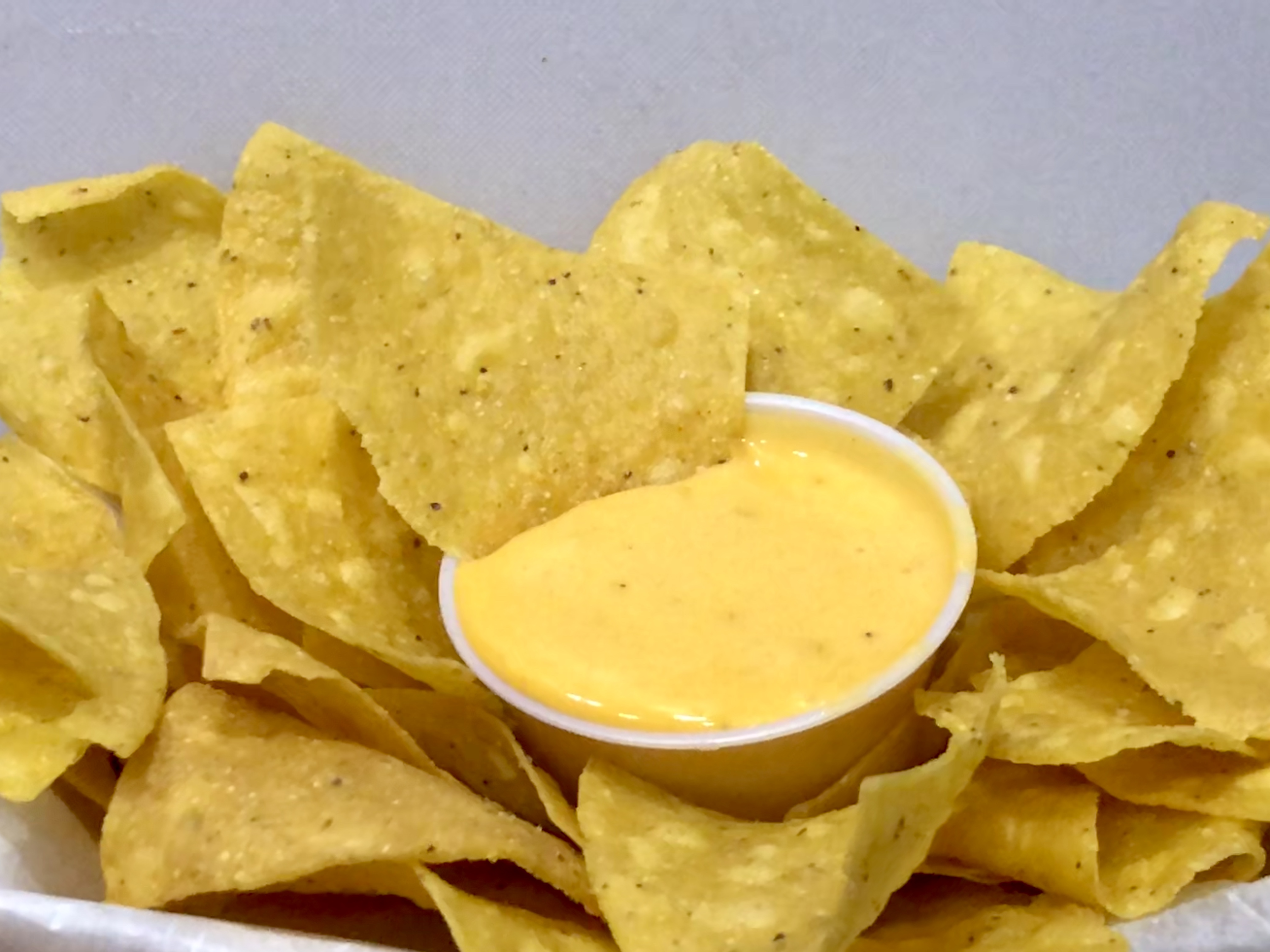 Order LARGE (8 oz) Homemade Queso and Chips food online from El barrio burritos store, Brooklyn on bringmethat.com