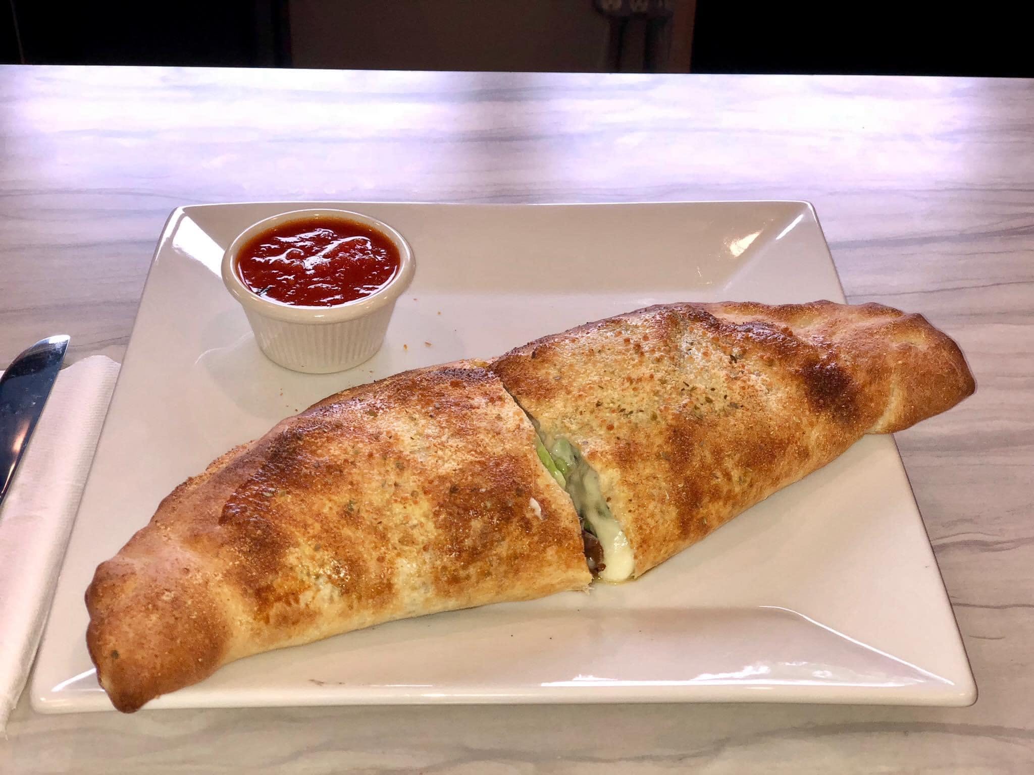 Order Calzone - Calzone food online from Two Brothers Cafe & Pizzeria store, Utica on bringmethat.com