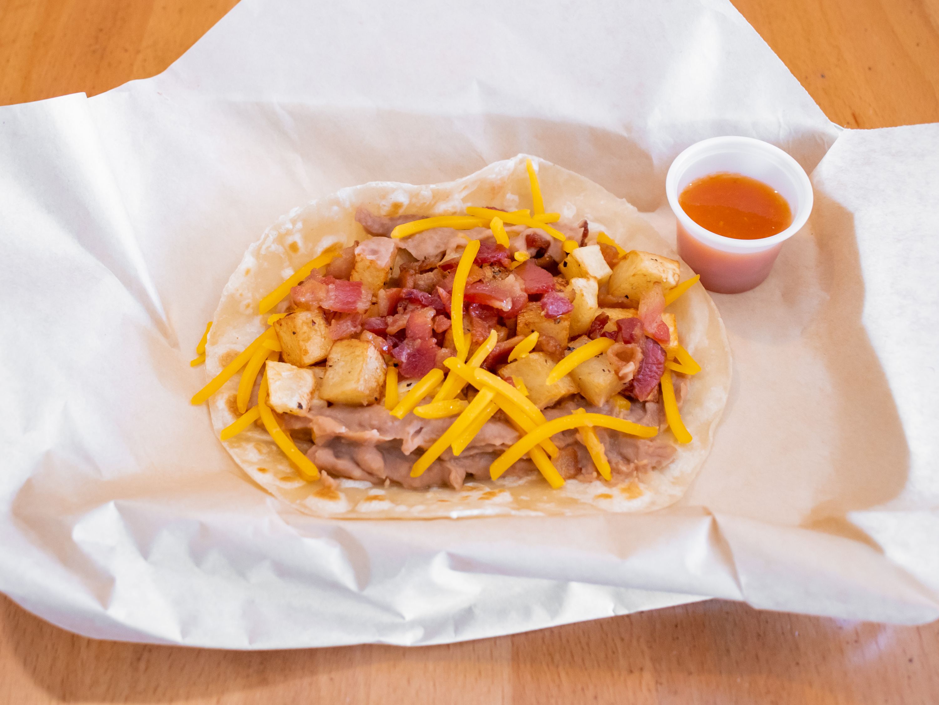 Order Bean, Cheese, Bacon and Potato Breakfast Taco food online from The Flame Tacos store, Seabrook on bringmethat.com