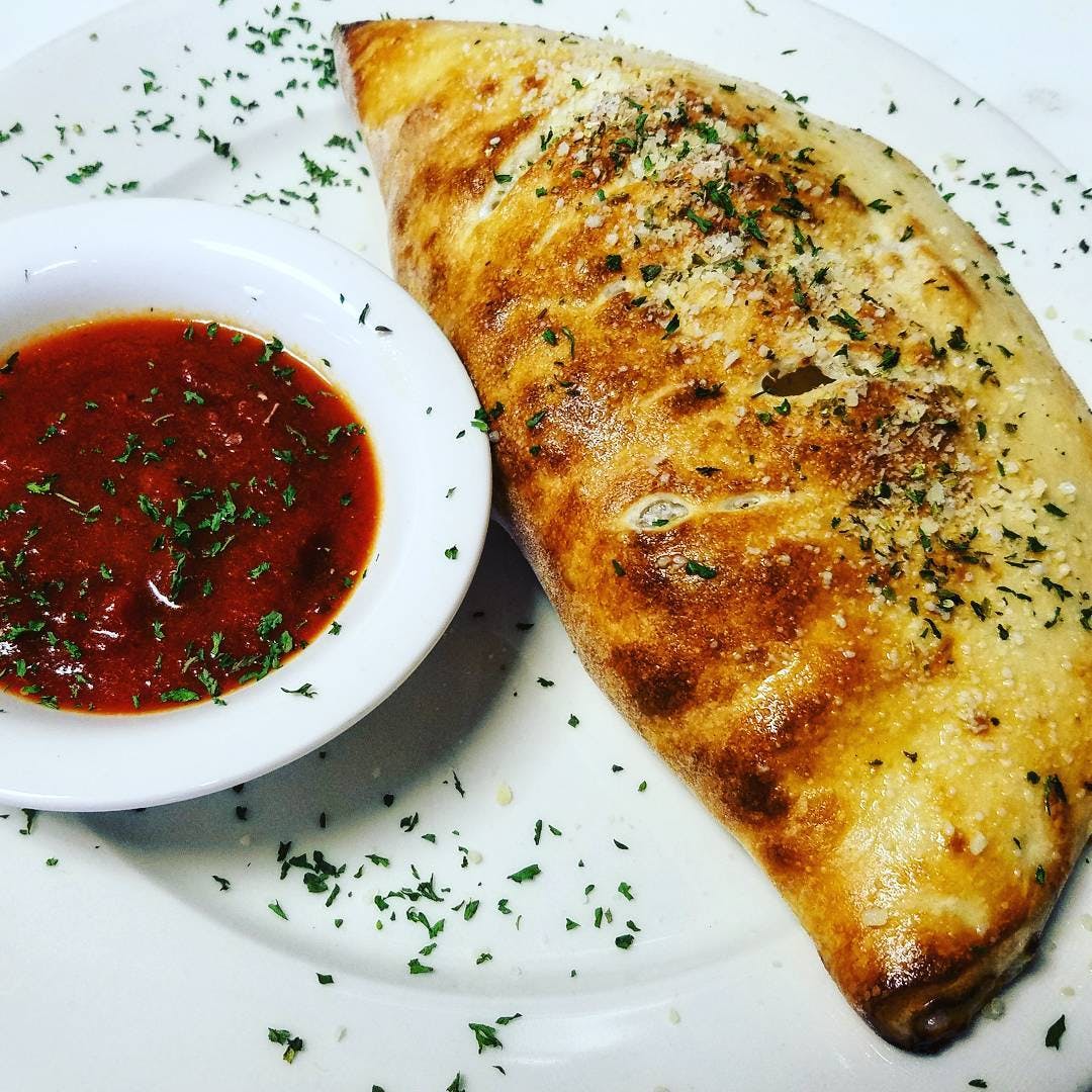 Order Meat Calzone - Calzone food online from Goomba Pizza store, San Antonio on bringmethat.com