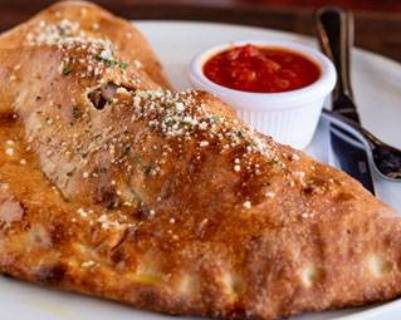 Order Greek Calzone food online from New York Pizzeria store, Houston on bringmethat.com