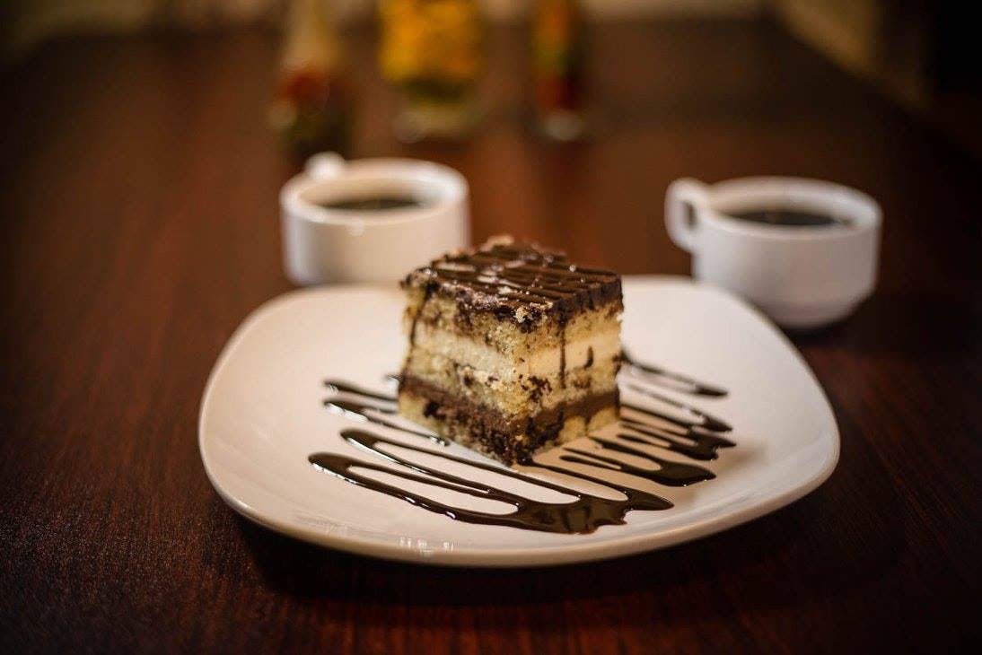 Order Truffle Tuxedo Cheesecake - Dessert food online from Zeko's Italian Restaurant store, Whiteville on bringmethat.com
