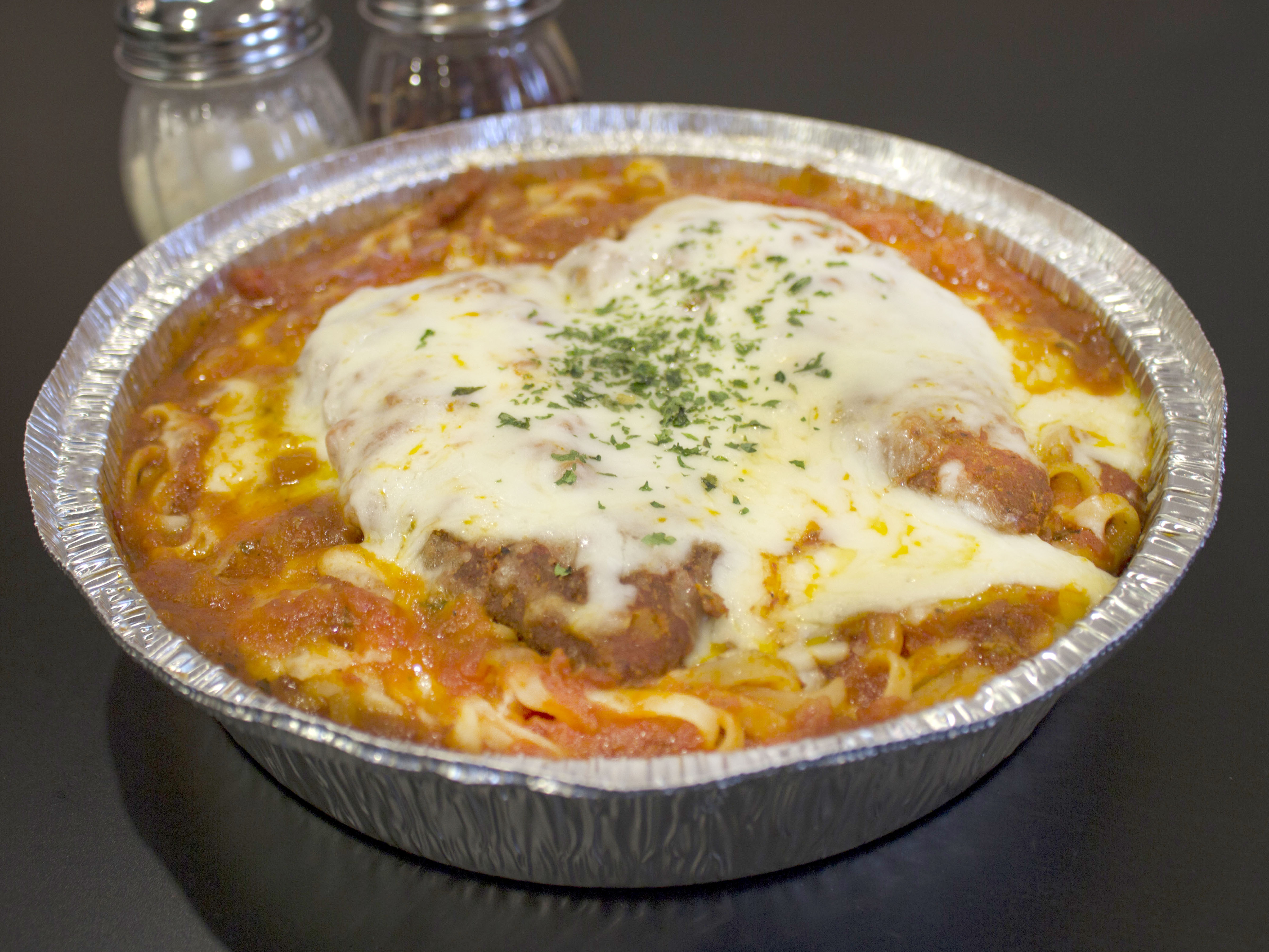 Order Chicken Parmigiana Over Linguini Dinner food online from Gallo Pizza and Subs store, Rochester on bringmethat.com