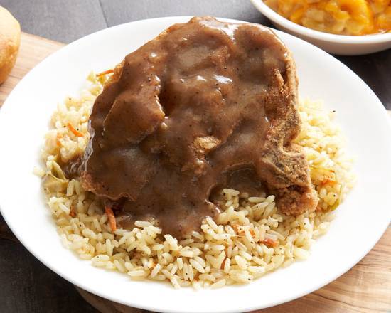Order Smothered Pork Chops W/ Brown Gravy Over Sassy Rice food online from This Is It! Bbq & Seafood Full Service store, East Point on bringmethat.com