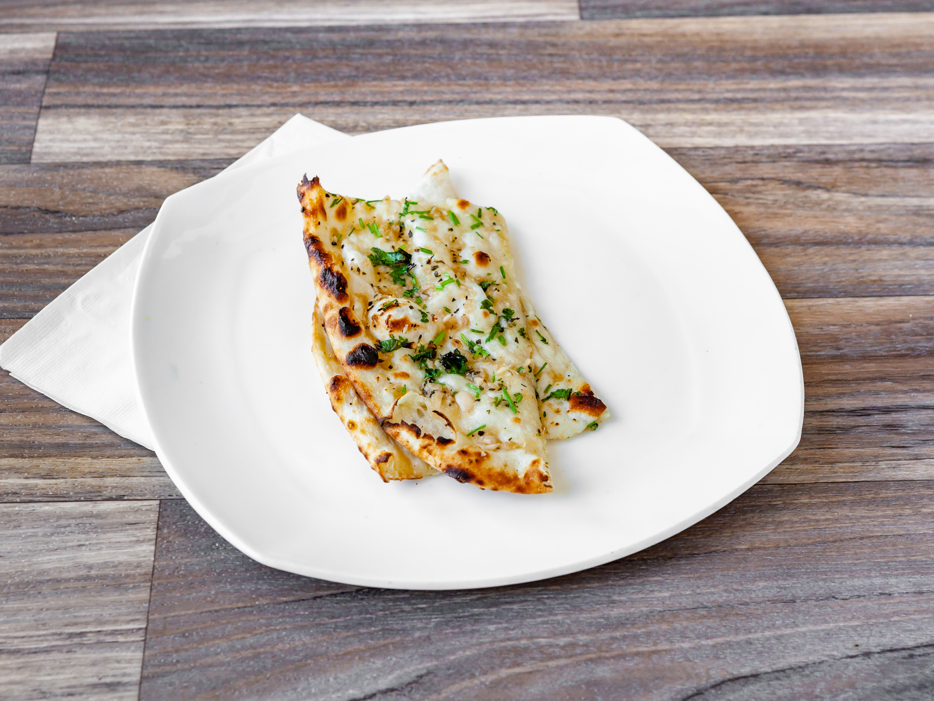 Order Garlic-Basil Naan food online from East India Grill store, Los Angeles on bringmethat.com