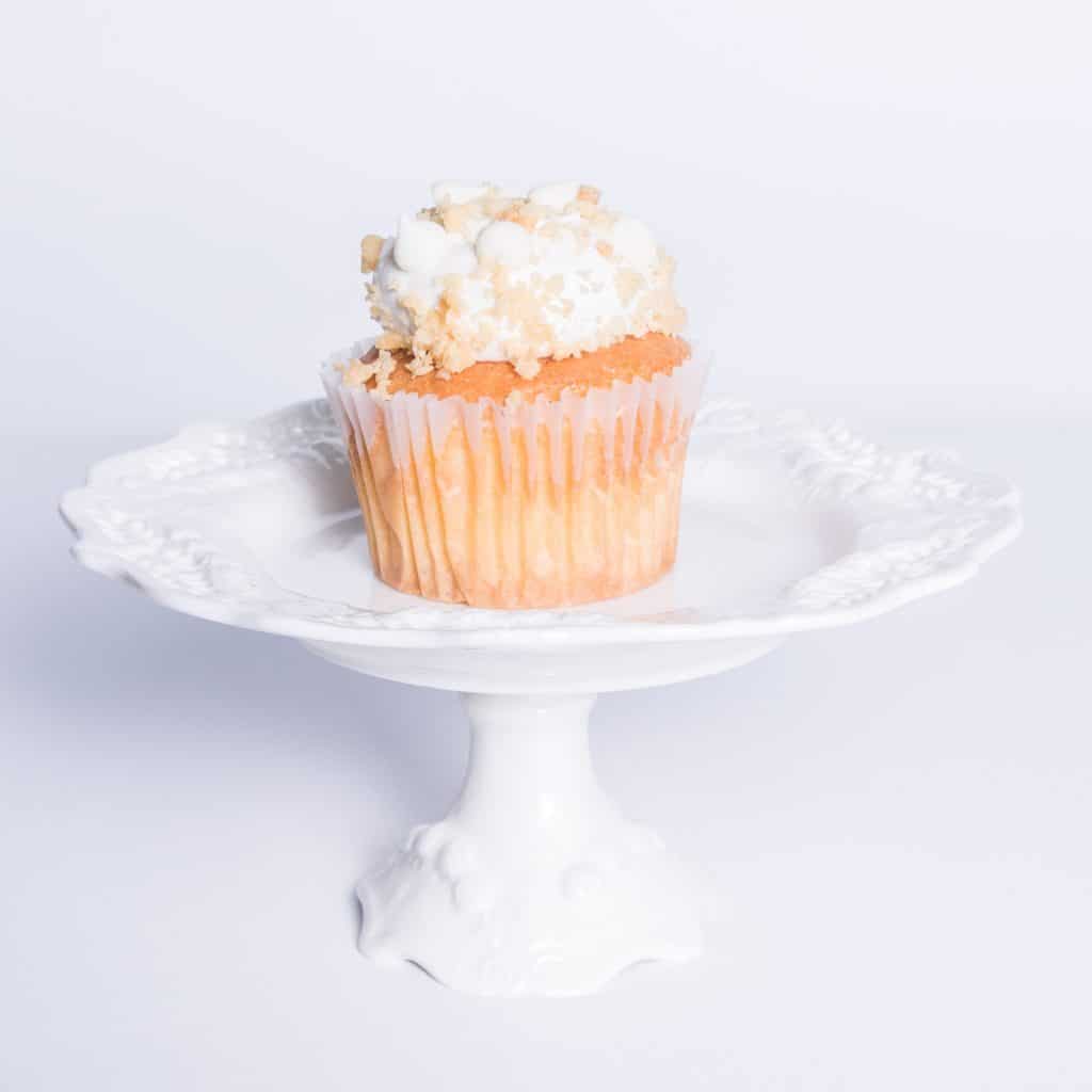 Order White Chocolate Macadamia Cupcake food online from Camicakes Creamery store, Smyrna on bringmethat.com