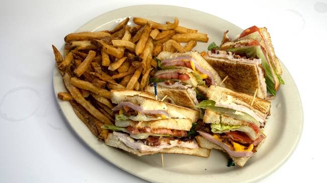 Order Triple Decker Club Sandwich w/ Fries food online from Snuffer's Restaurant & Bar store, Dallas on bringmethat.com