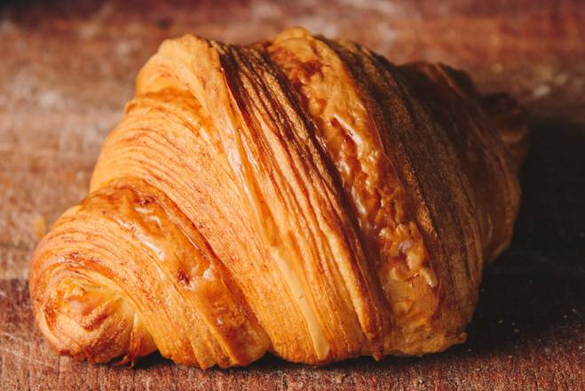 Order Classic butter croissant food online from Badolina Bakery &amp; Cafe store, Houston on bringmethat.com