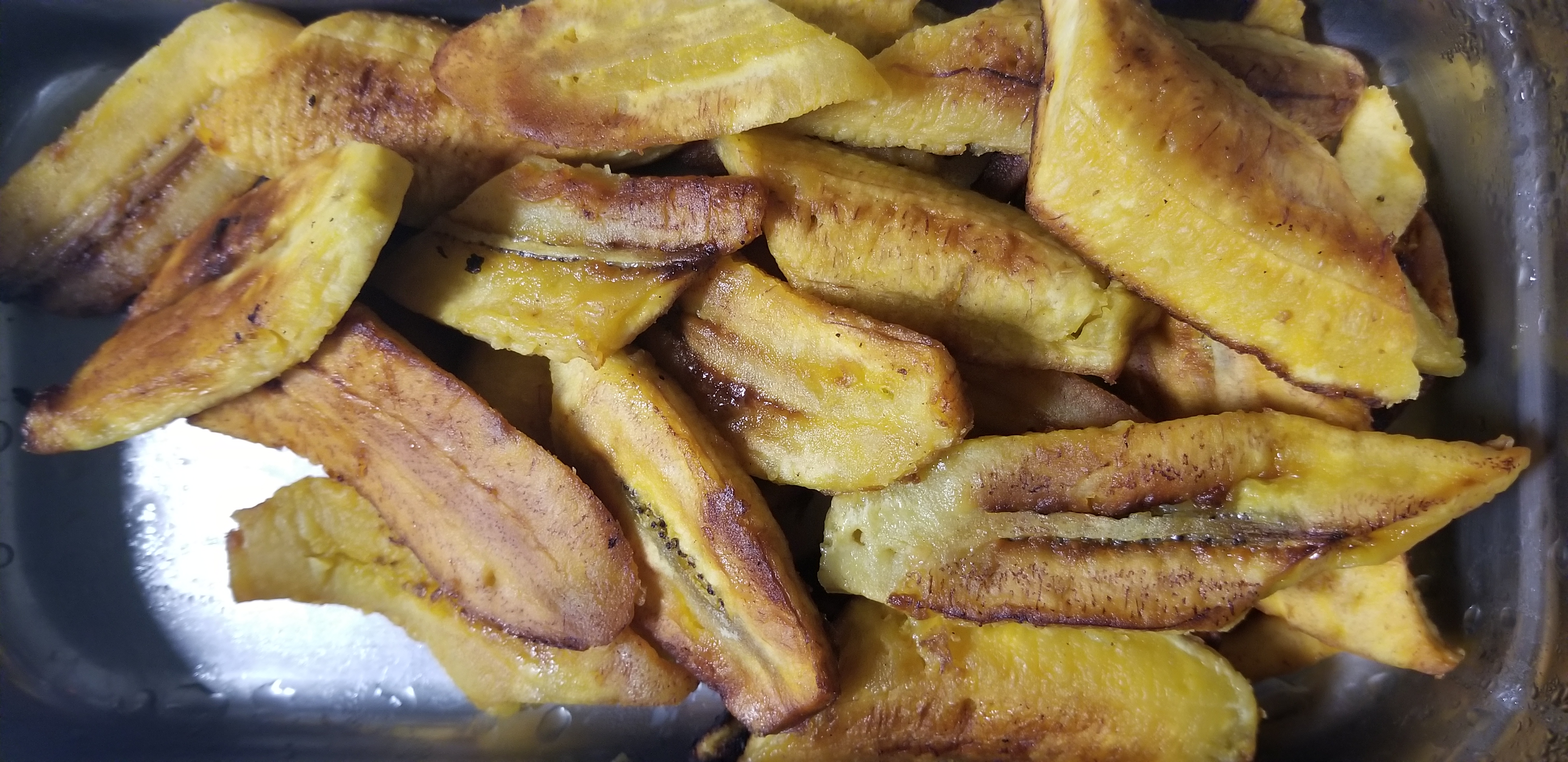 Order (3) extra pieces plaintains food online from Huzzys Jamaican Restaurant store, Houston on bringmethat.com