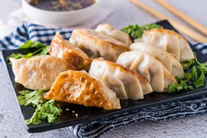 Order A07.Fried Dumplings (8) 锅贴 food online from Happy Dragon store, Kansas City on bringmethat.com