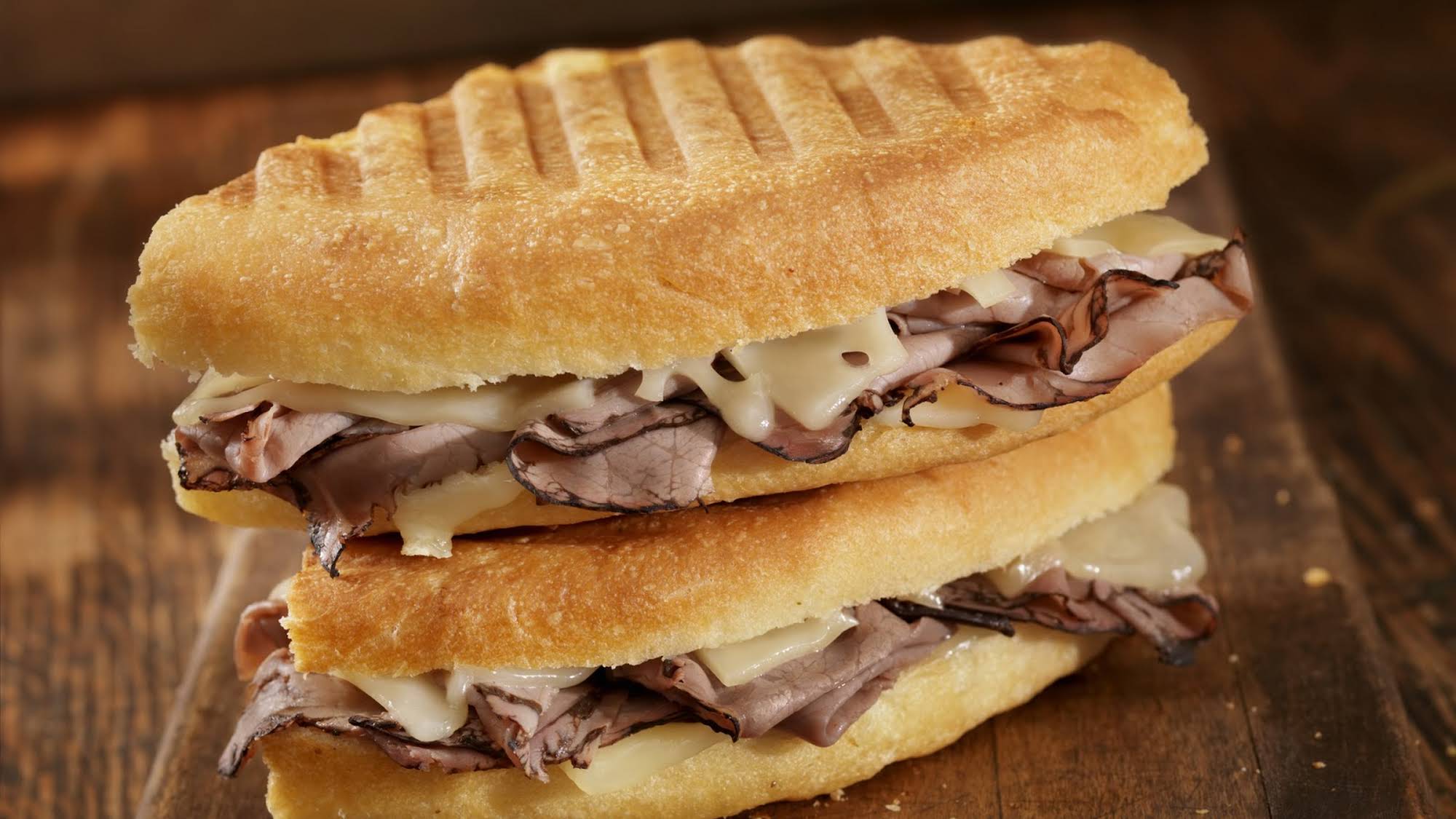 Order 9. Roast Beef Panini food online from Cafe Deli-Cious store, New York on bringmethat.com