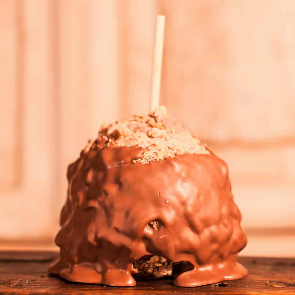 Order Caramel Apple Covered in Twix® Candy topped with Milk Chocolate food online from Candy Apple Shoppe store, Glenwood on bringmethat.com