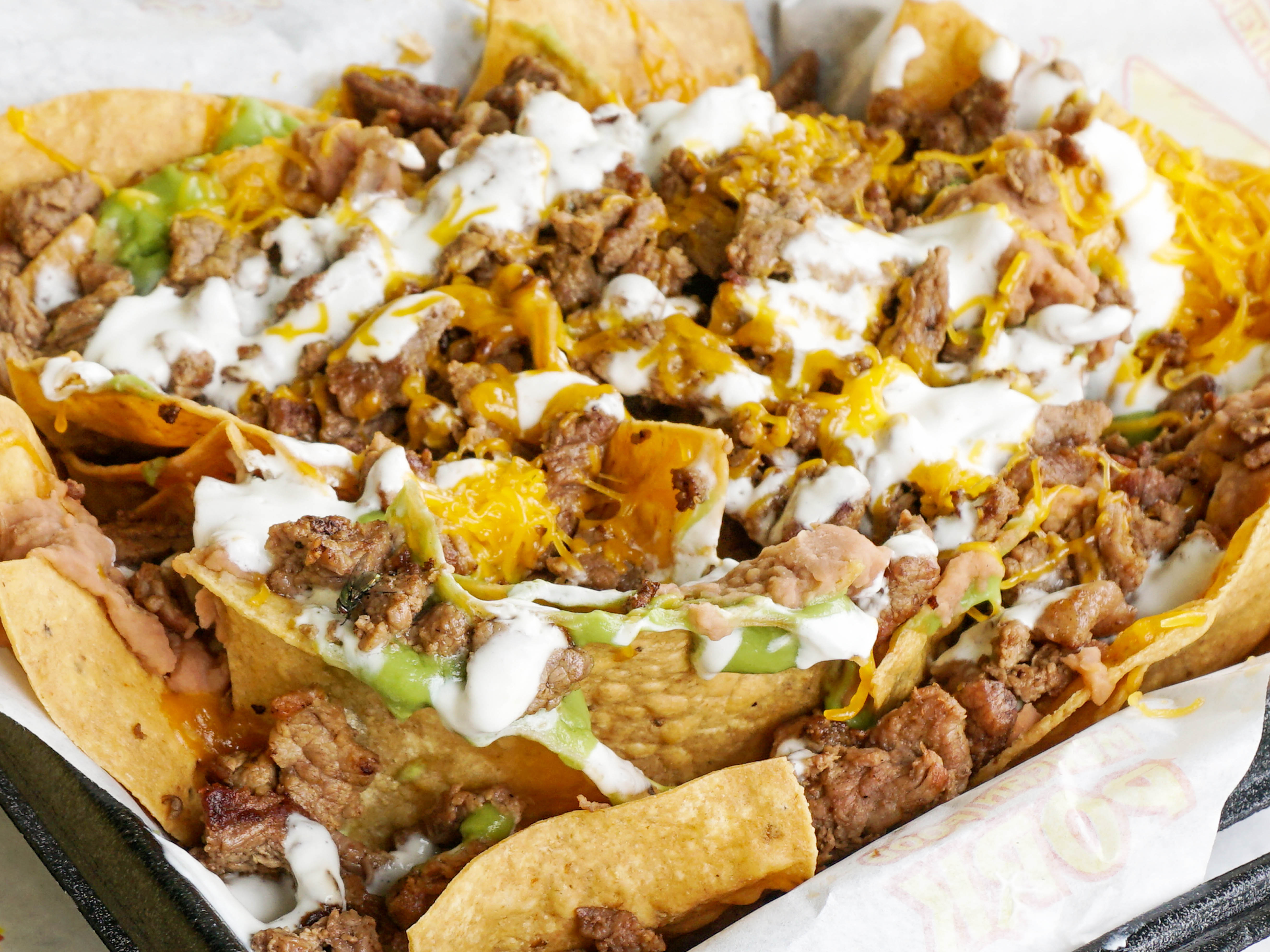 Order Super Nachos food online from Filiberto's Mexican Food store, San Diego on bringmethat.com