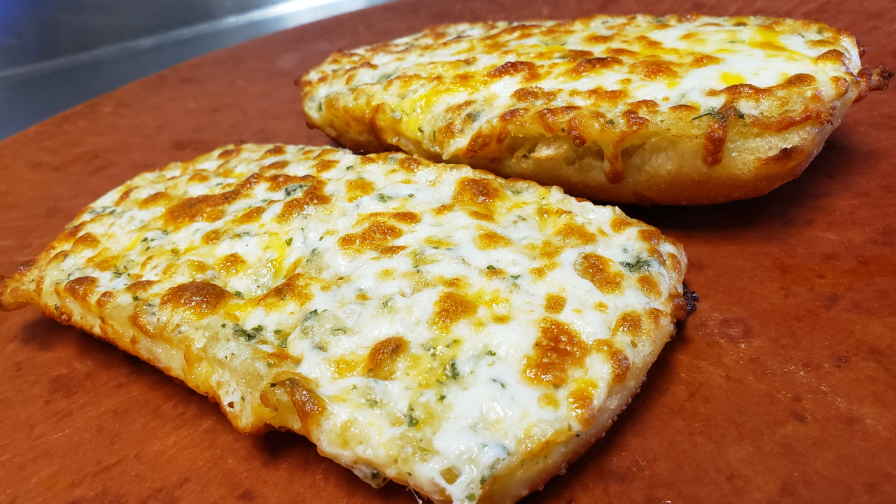 Order Garlic Bread with Cheese food online from Round Table Pizza store, San Jose on bringmethat.com