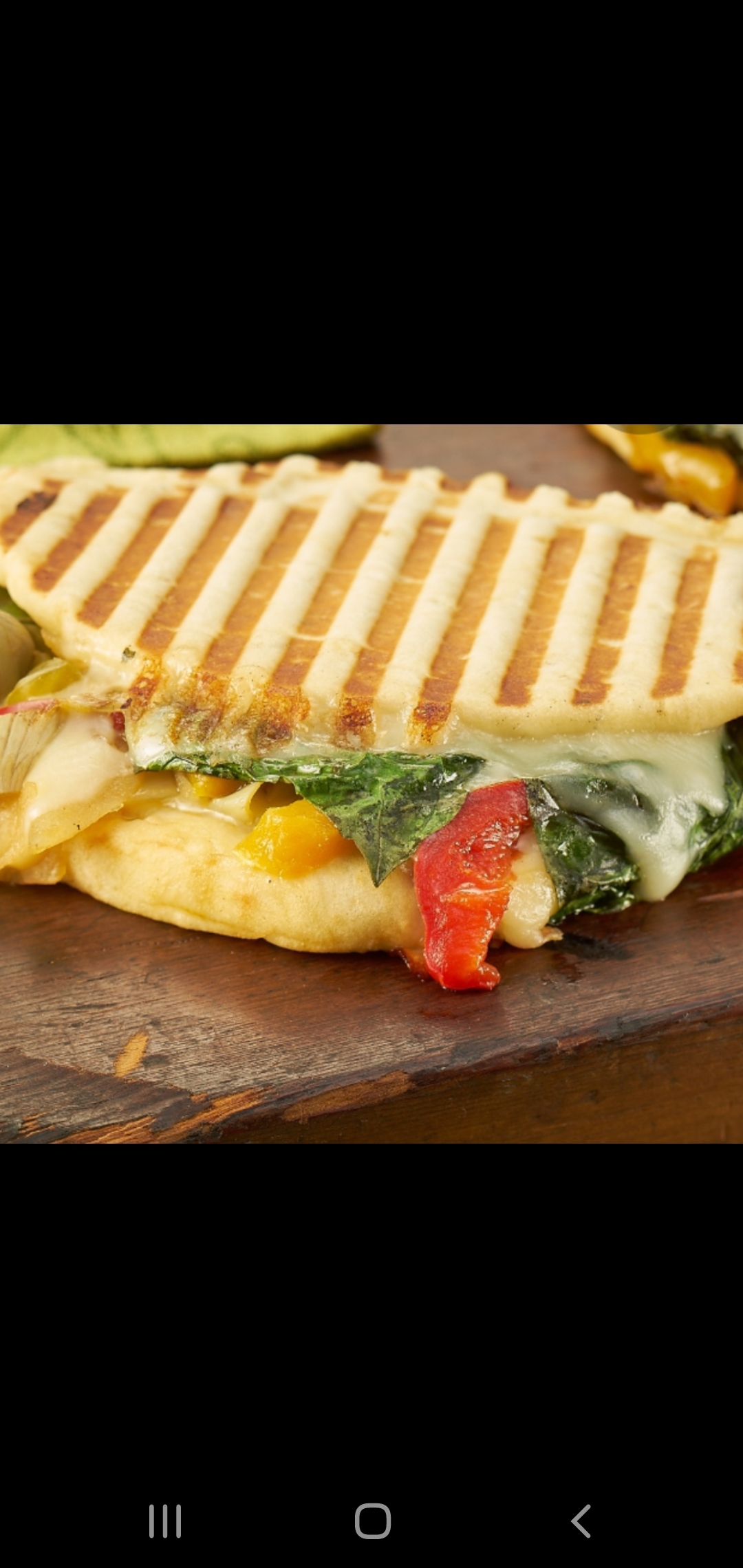 Order Vegetarian Panini (grilled mushrooms eggplant roasted peppers spinach fresh mozzarella & parmesan cheese) food online from American Gourmet Foods Deli store, New York on bringmethat.com