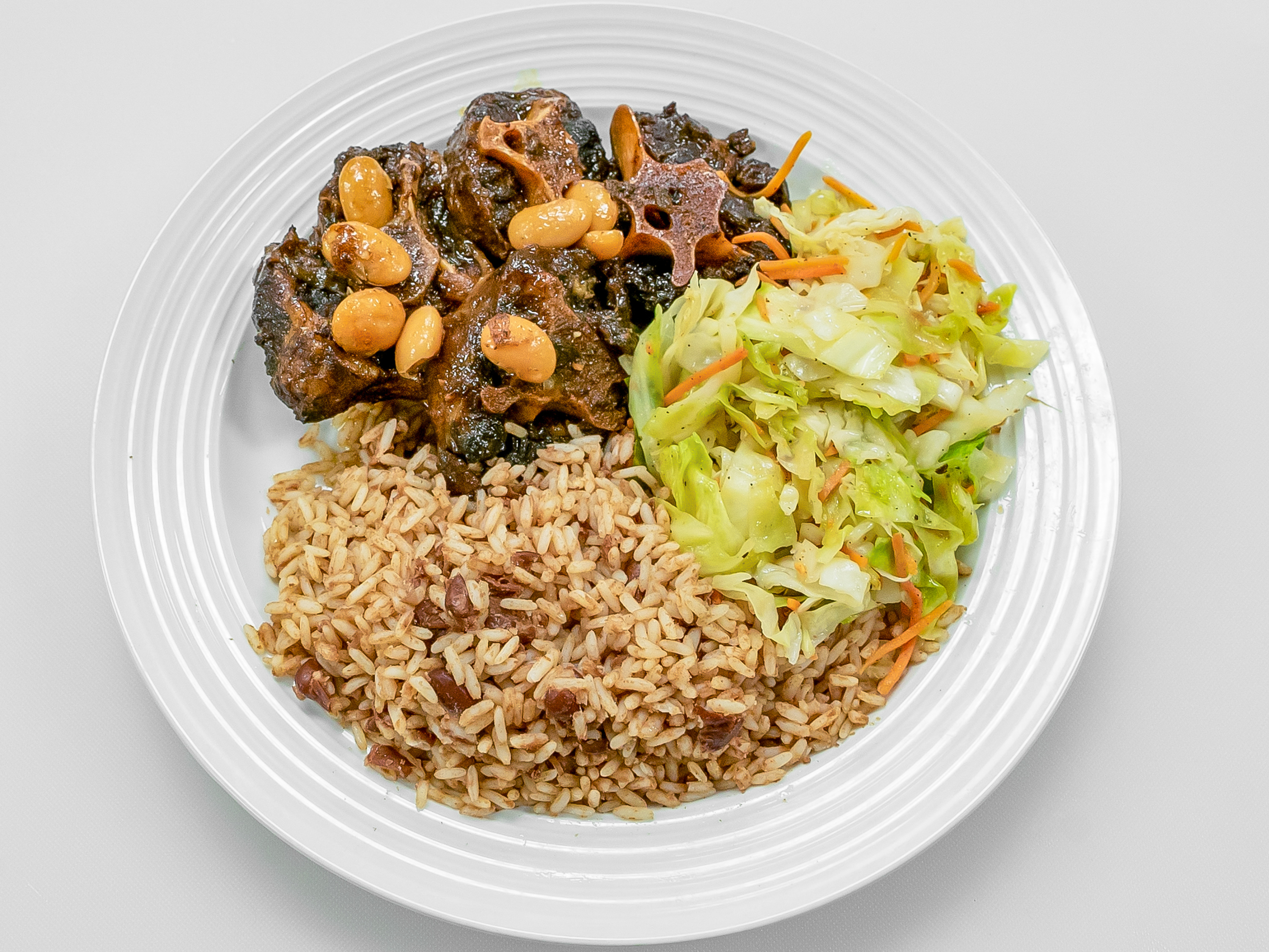 Order Oxtail food online from Cool Runnings Eatery store, White Plains on bringmethat.com