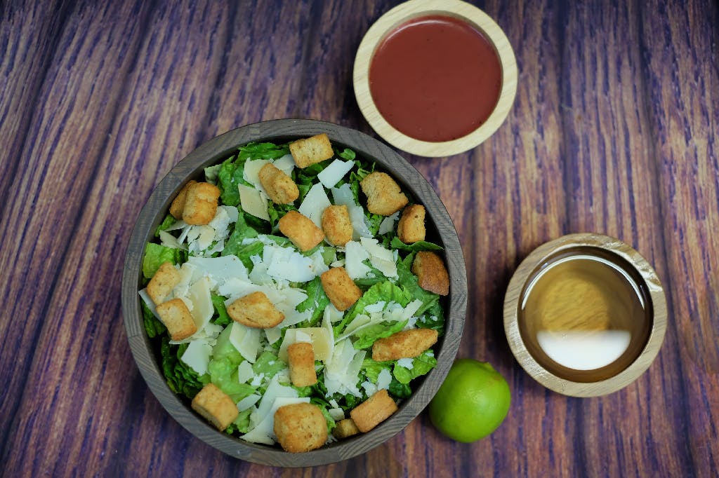 Order Caesar Salad - Salad food online from Oscar's Pizza store, Colonie on bringmethat.com