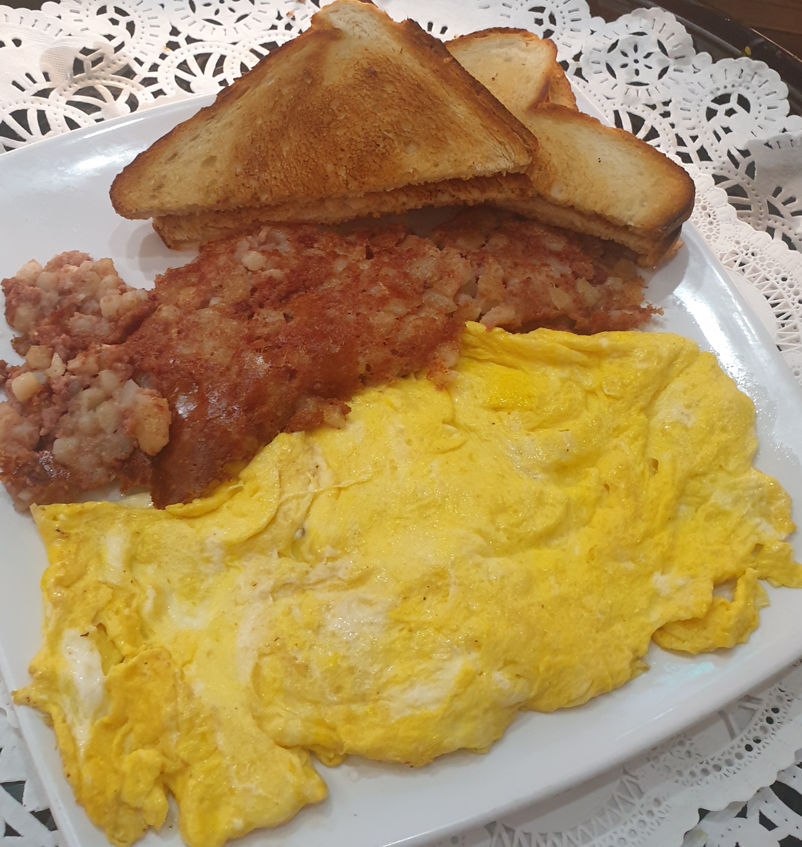Order 3 eggs over easy Corned Beef Hash Potatoes & Toast food online from Taz Cafe store, New York on bringmethat.com