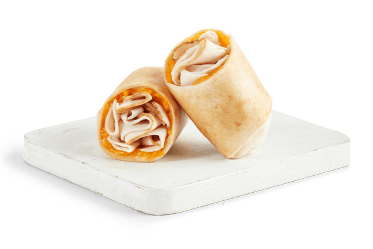 Order TURKEY & CHEDDAR WRAP food online from Tropical Smoothie Cafe store, Atlanta on bringmethat.com