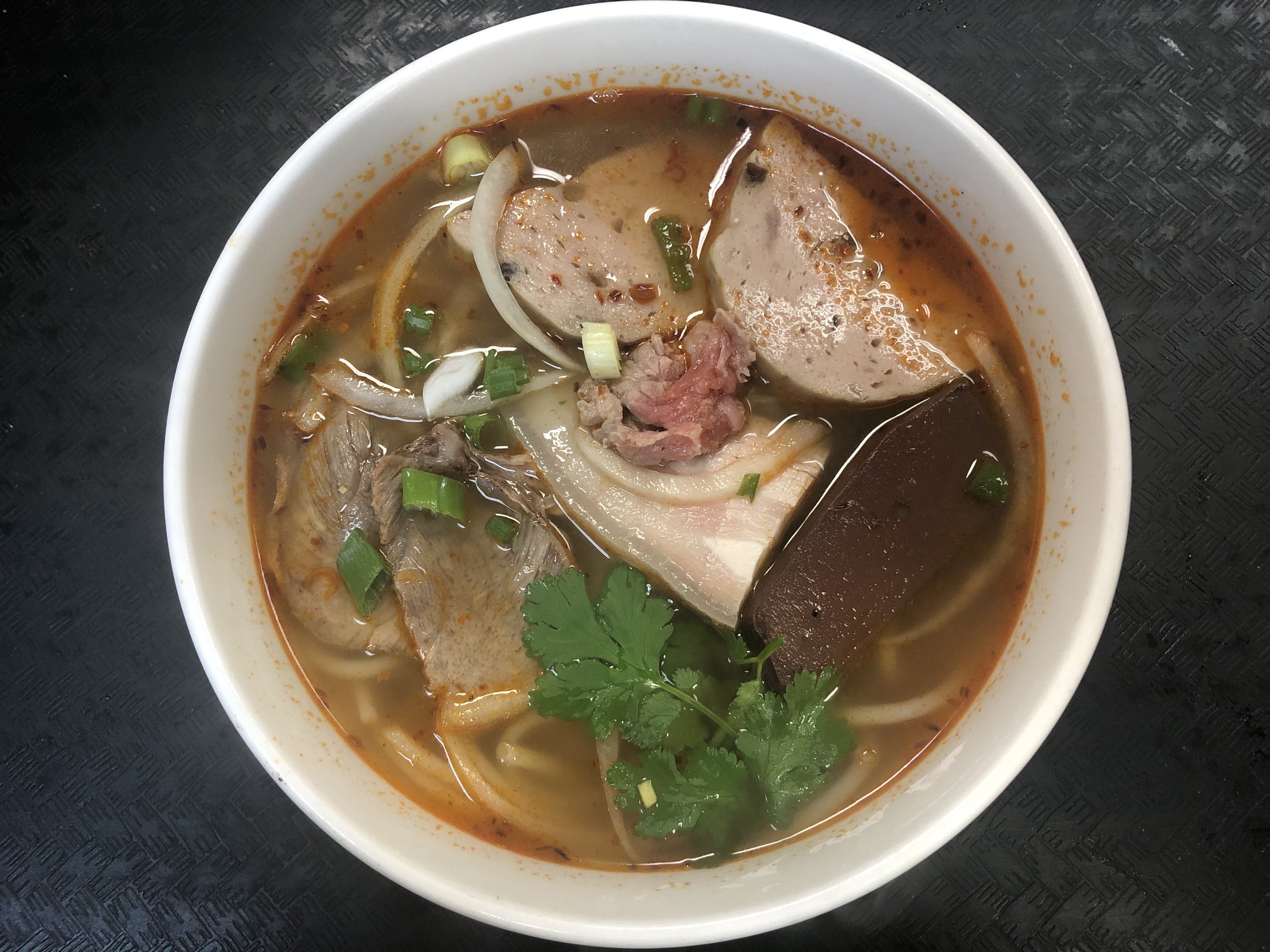 Order 33. Spicy Beef noodle soup (Bún Bò Huế) food online from Saigon House store, San Leandro on bringmethat.com