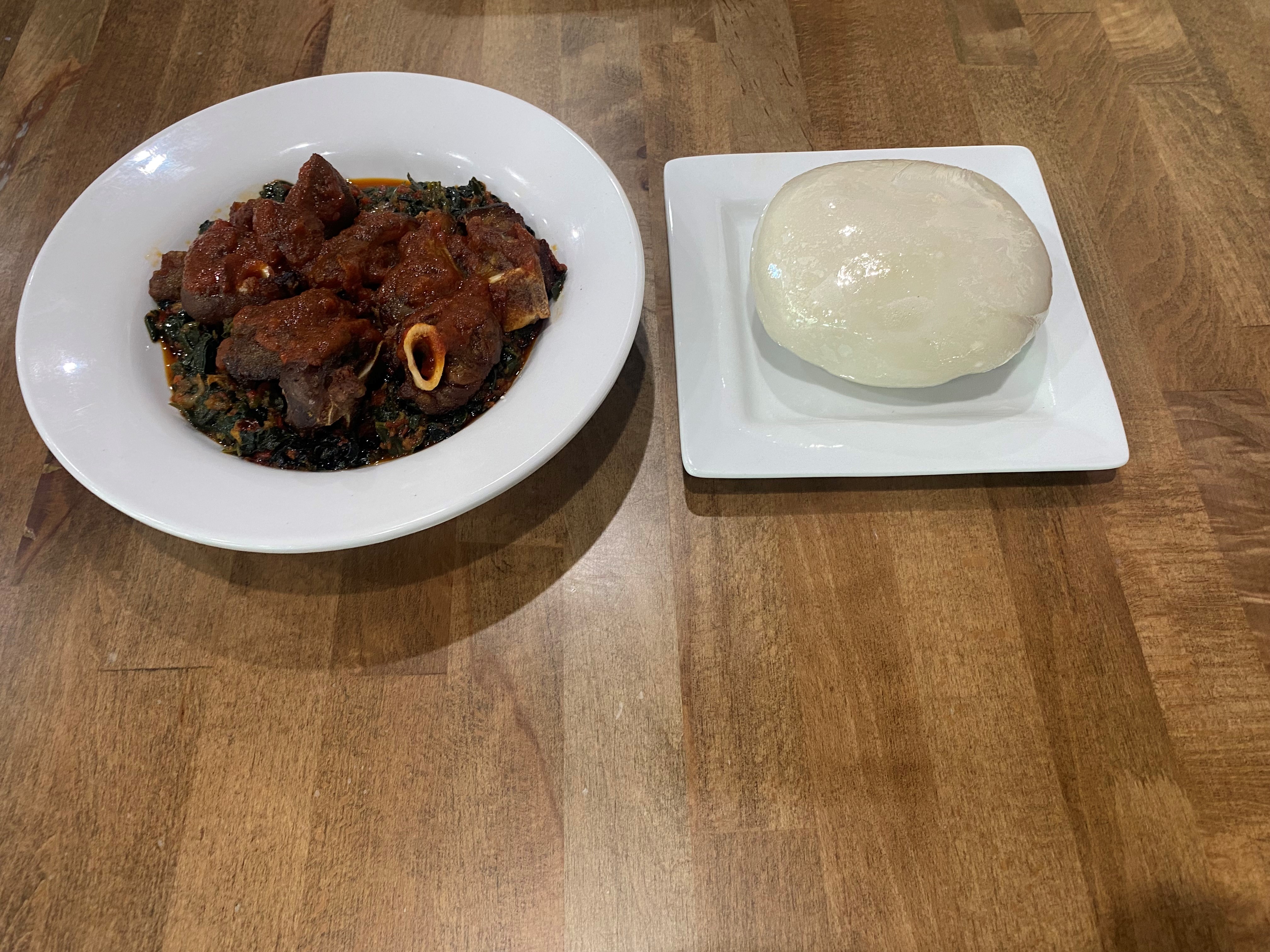 Order Poundo-Fufu + Efo Riro-Spinach + Goat Meat food online from Fusion Vibes Kitchen + Bar store, Richardson on bringmethat.com