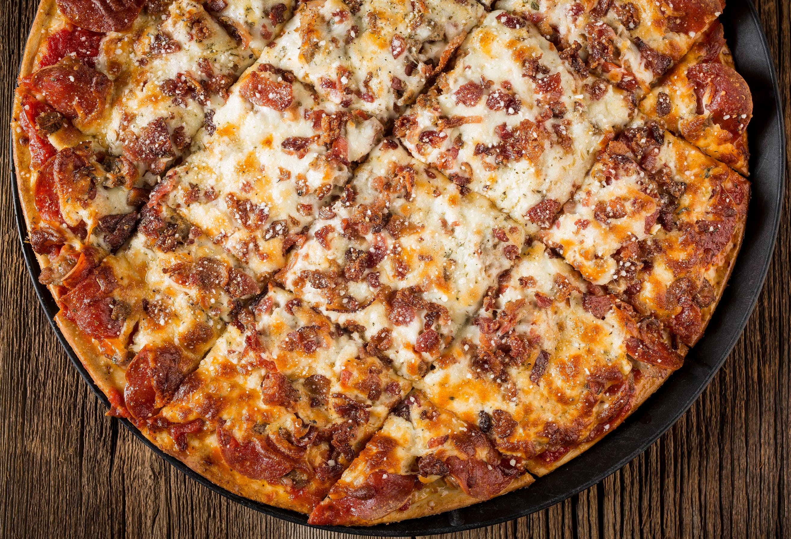 Order Meat Mania Pizza - 12" (12 Slices) (Serves 2 People) food online from Rosatis Pizza store, Crest Hill on bringmethat.com