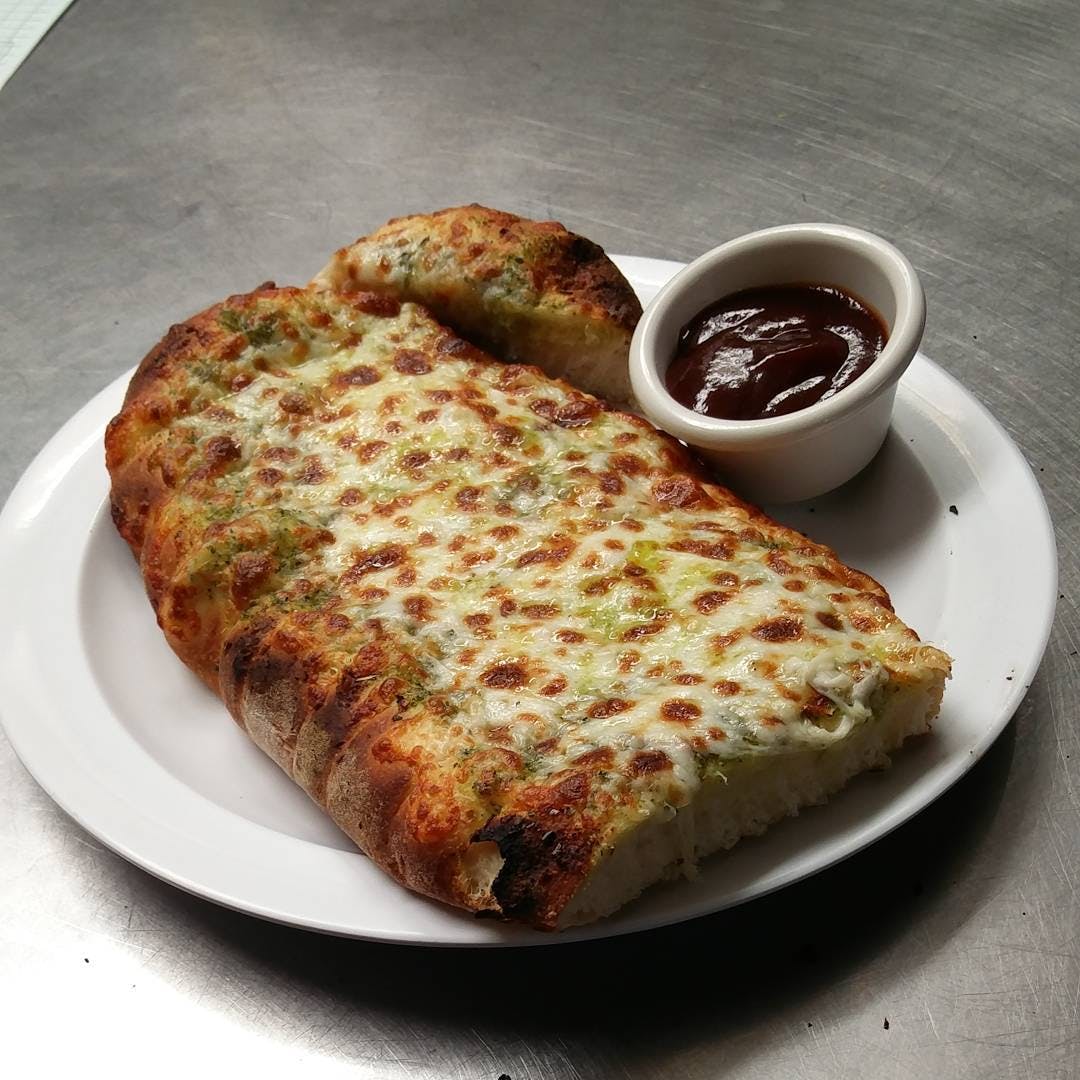Order Garlic Cheesy Pesto Bread - Appetizer food online from Poulsbo Woodfired Pizza  store, Poulsbo on bringmethat.com