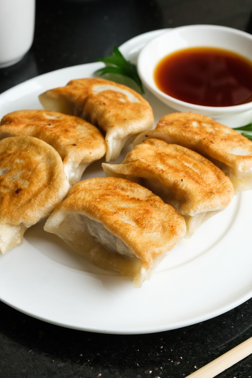 Order Pan Fried Chicken Dumplings- 6 pcs food online from The Bund store, Forest Hills on bringmethat.com