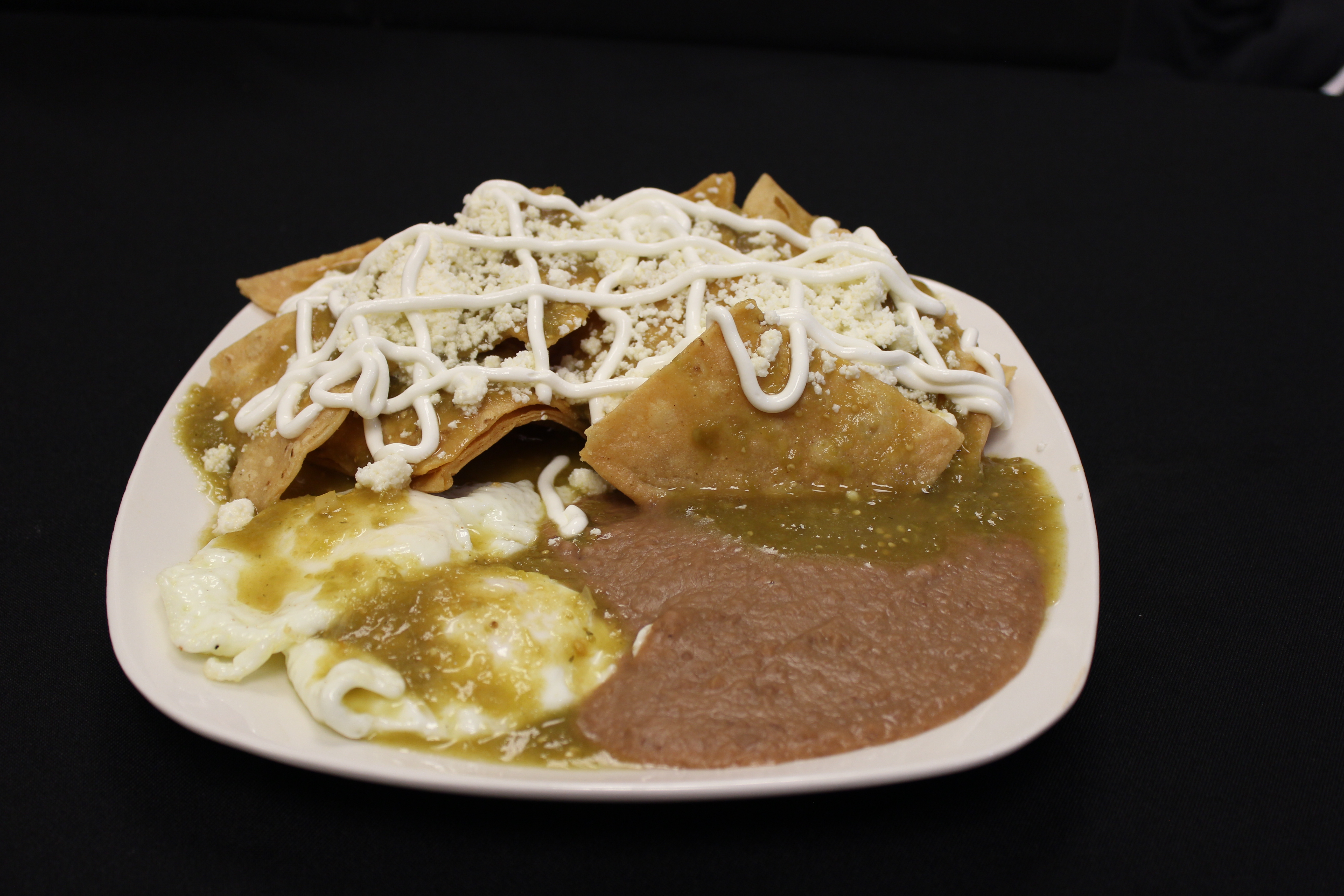 Order Chilaquiles Rojos and Verdes 2 Huevos and Frijoles food online from El Oregano store, Houston on bringmethat.com