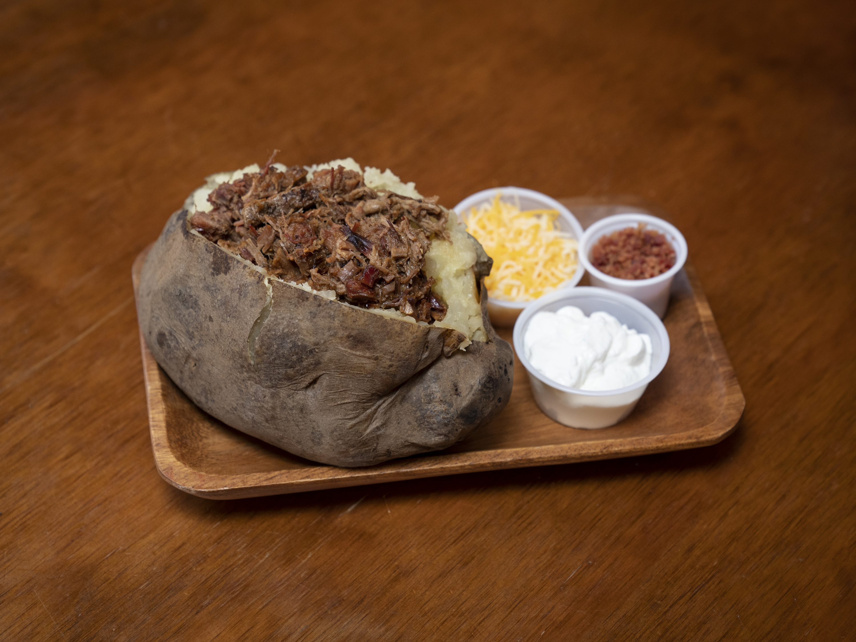 Order 12. Loaded Baked Potato food online from Briskets & Beer Smokehouse store, Laredo on bringmethat.com